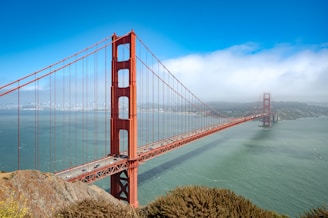 The golden gate bridge spans across the water.