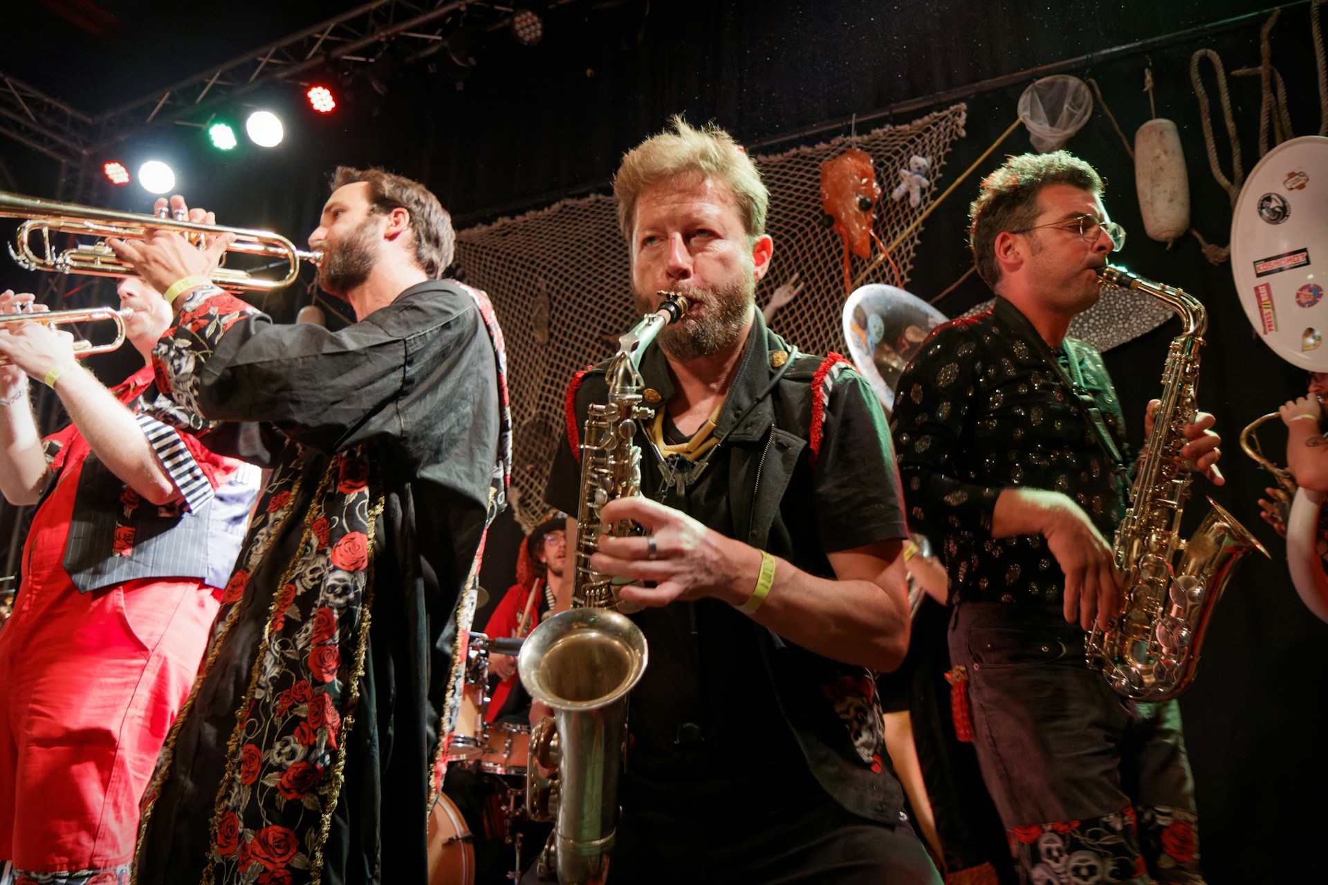 A brass band performs live on stage.