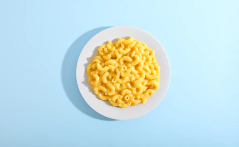 Mac and cheese served on a white plate.
