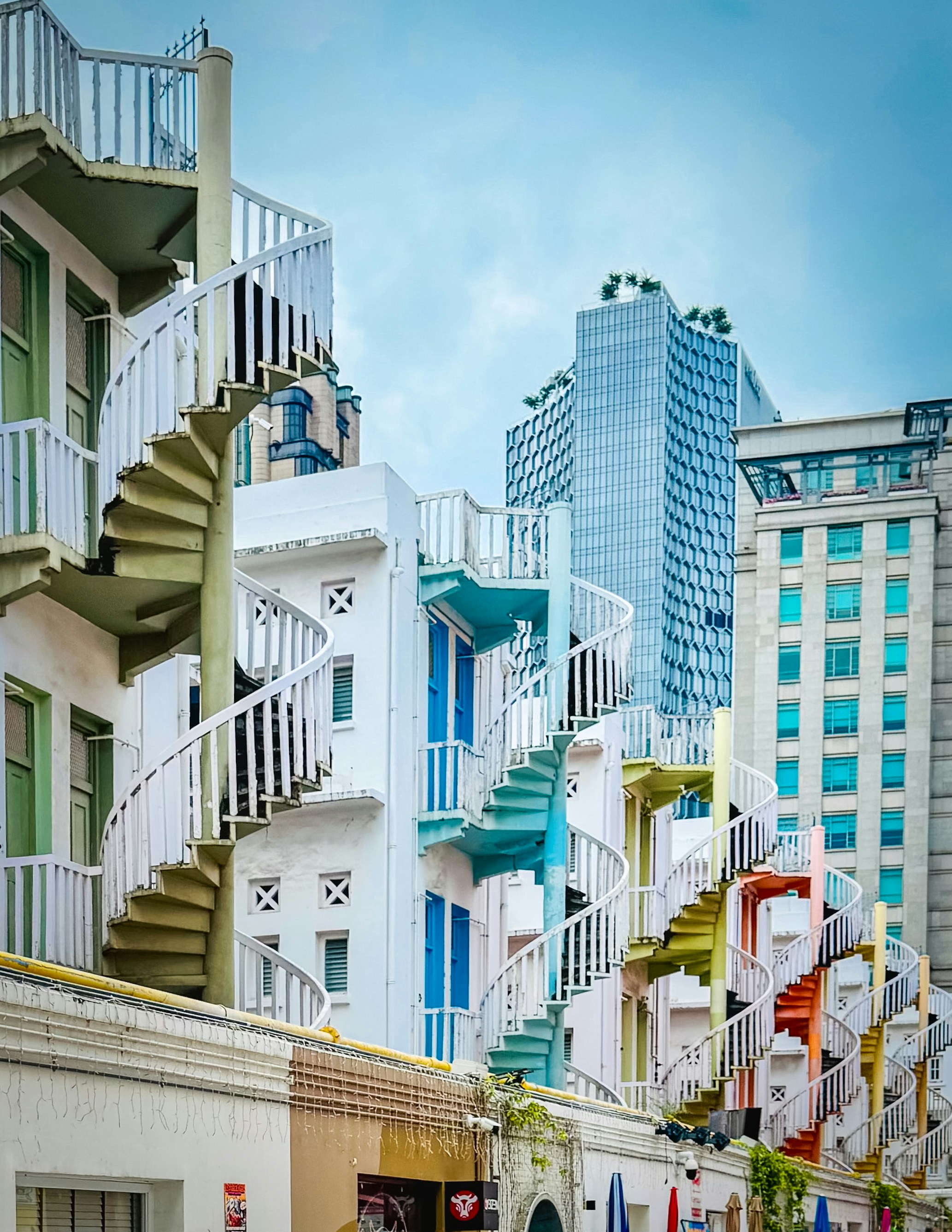 Spiral staircases adorn colorful buildings in the city