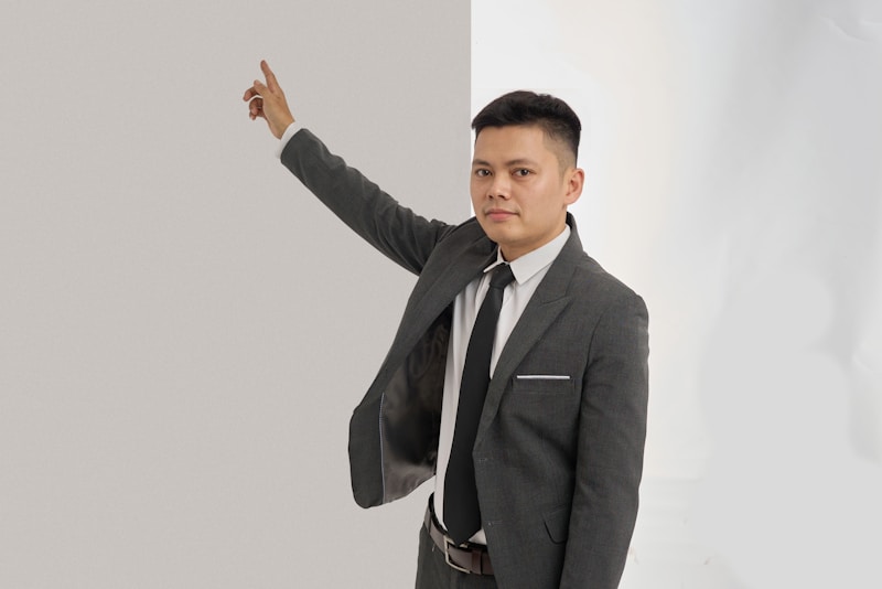 Sharp dressed man pointing up