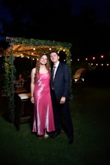 A couple smiles for a photo at a night event.