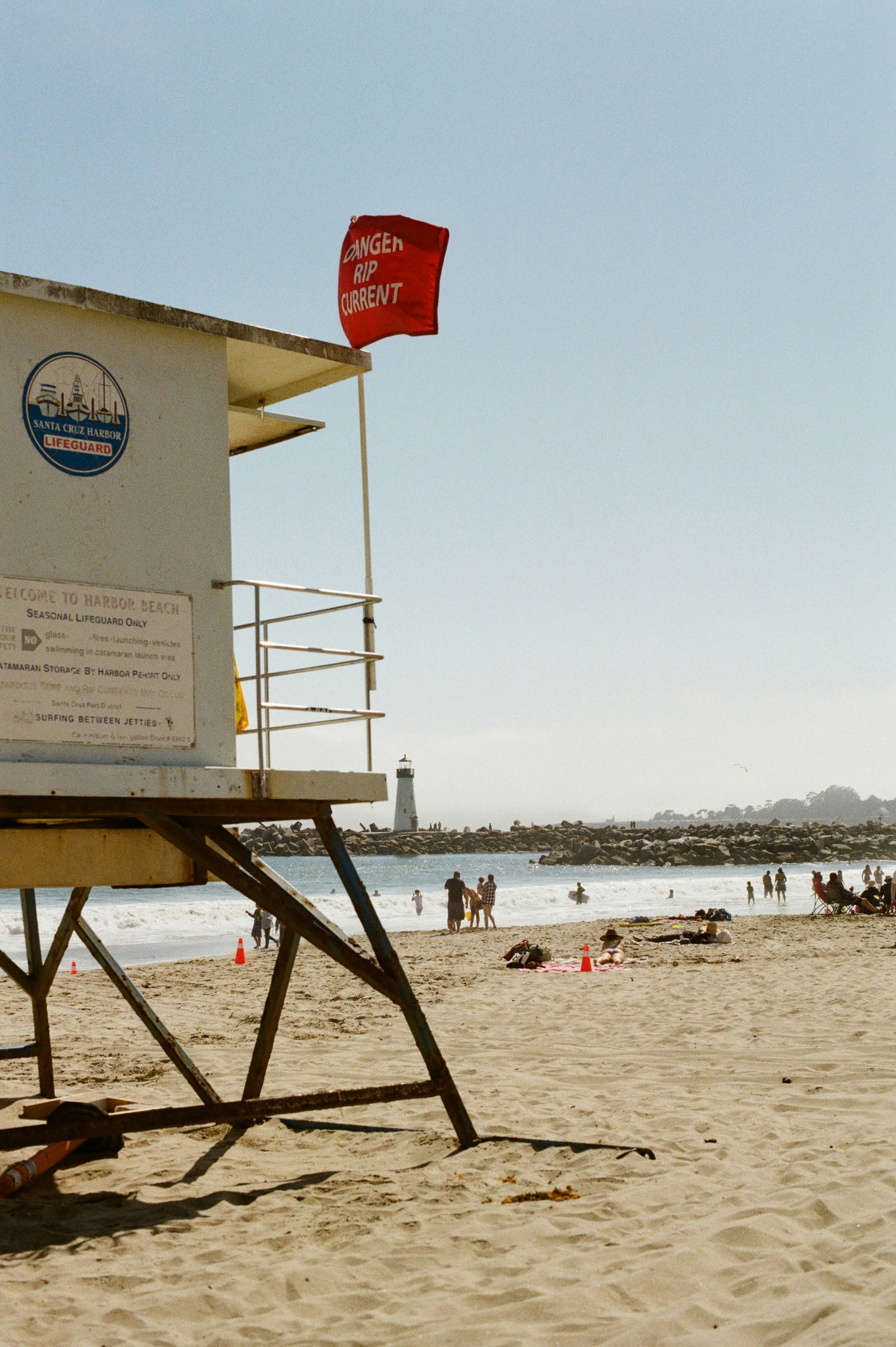 A beach with lifeguard station and "danger" flag