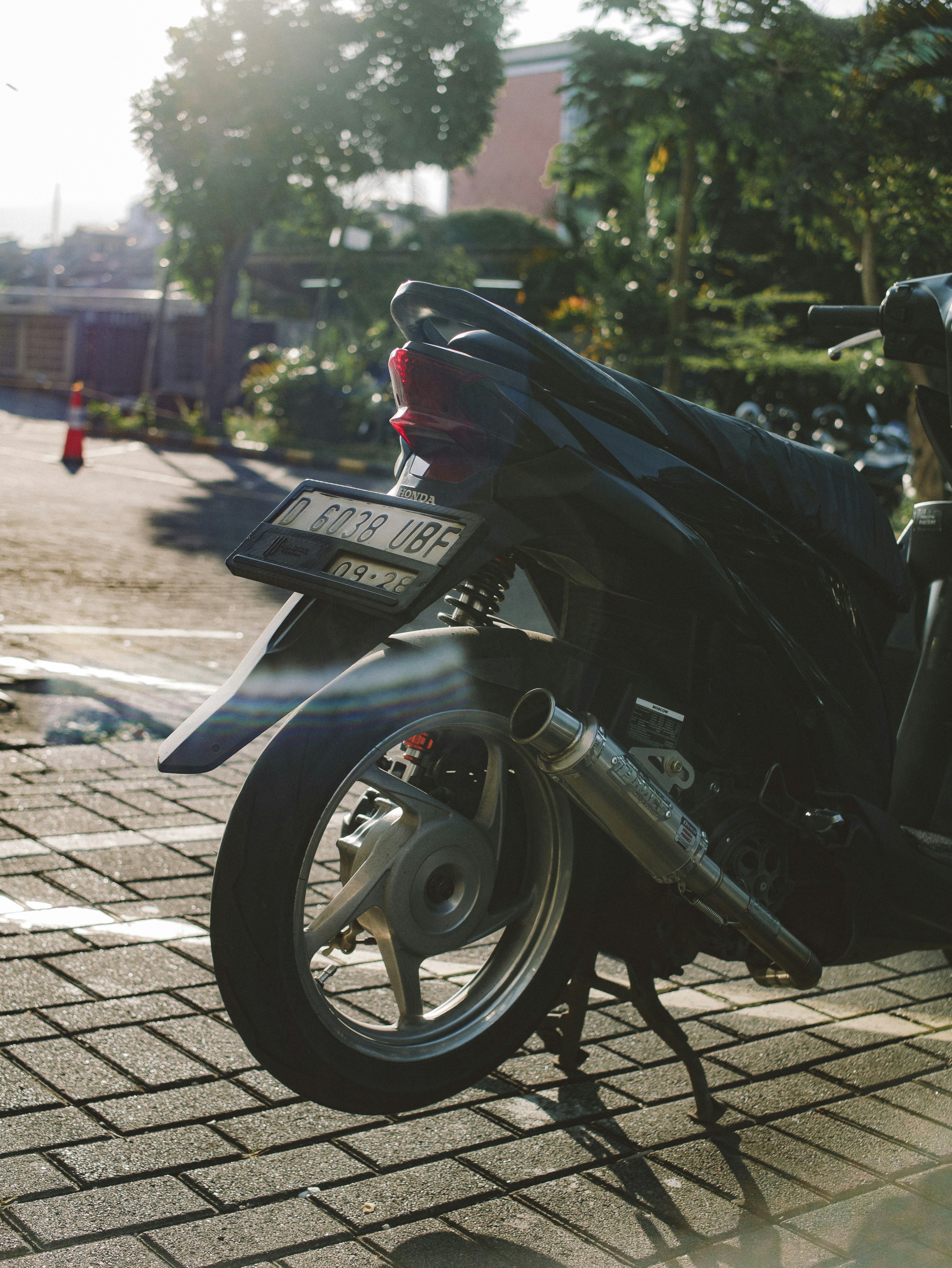 A motorcycle sits on a brick road.
