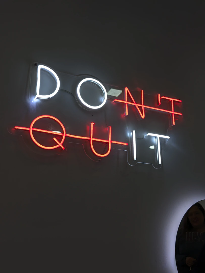 The neon sign says "don't quit."