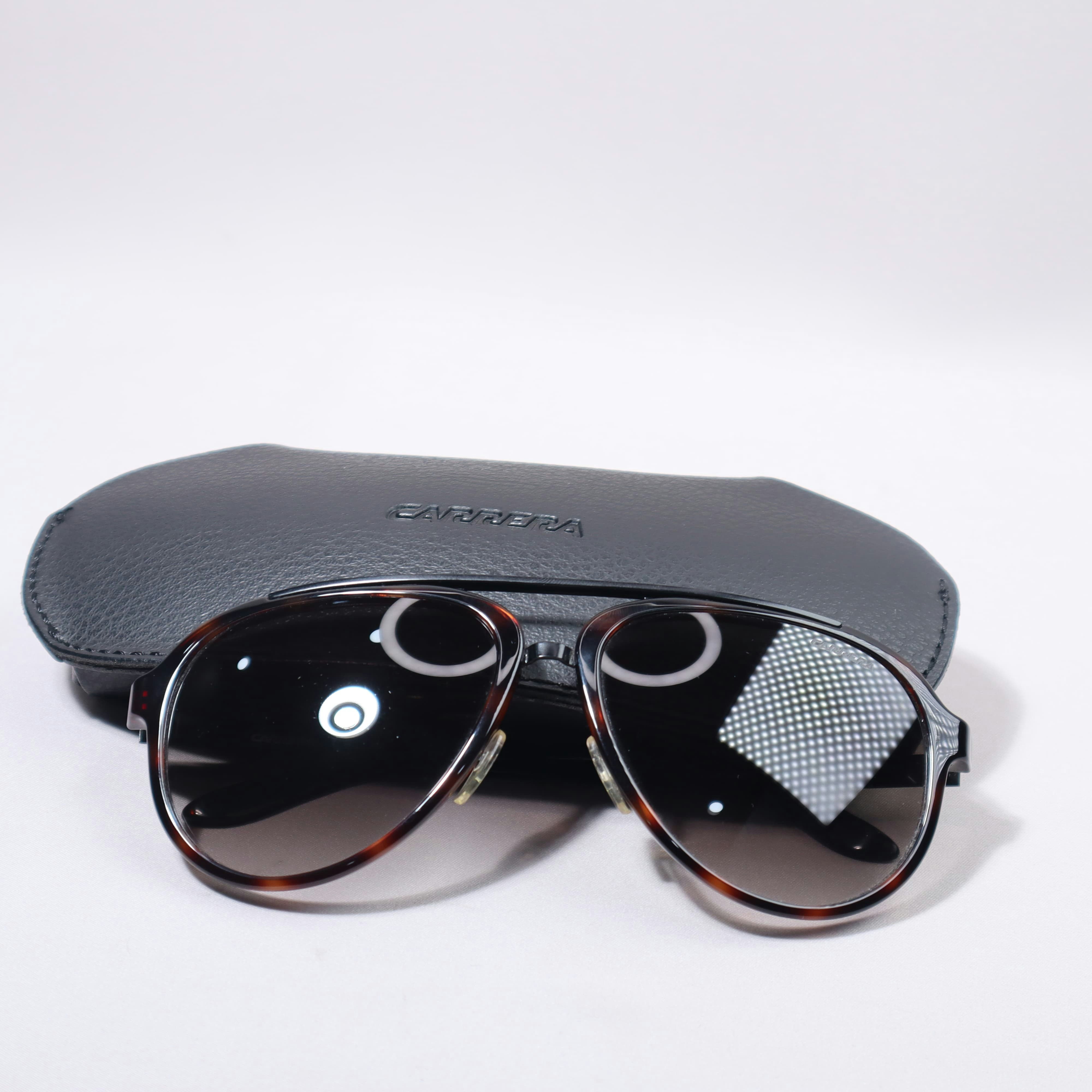 Sunglasses and their case are visible.