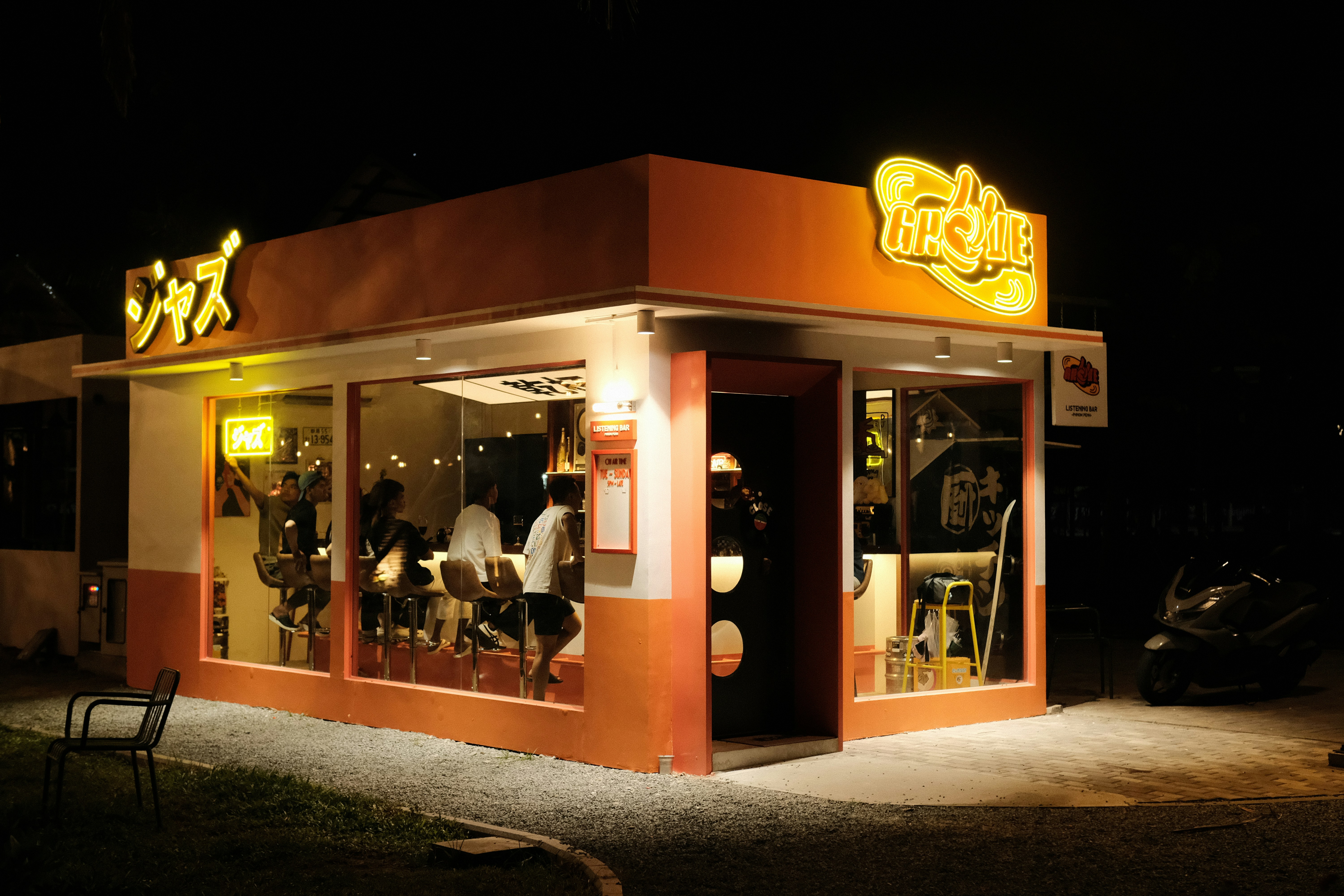 A cozy restaurant glows at night.