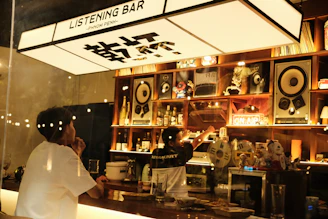 A bar with speakers and a "listening bar" sign.