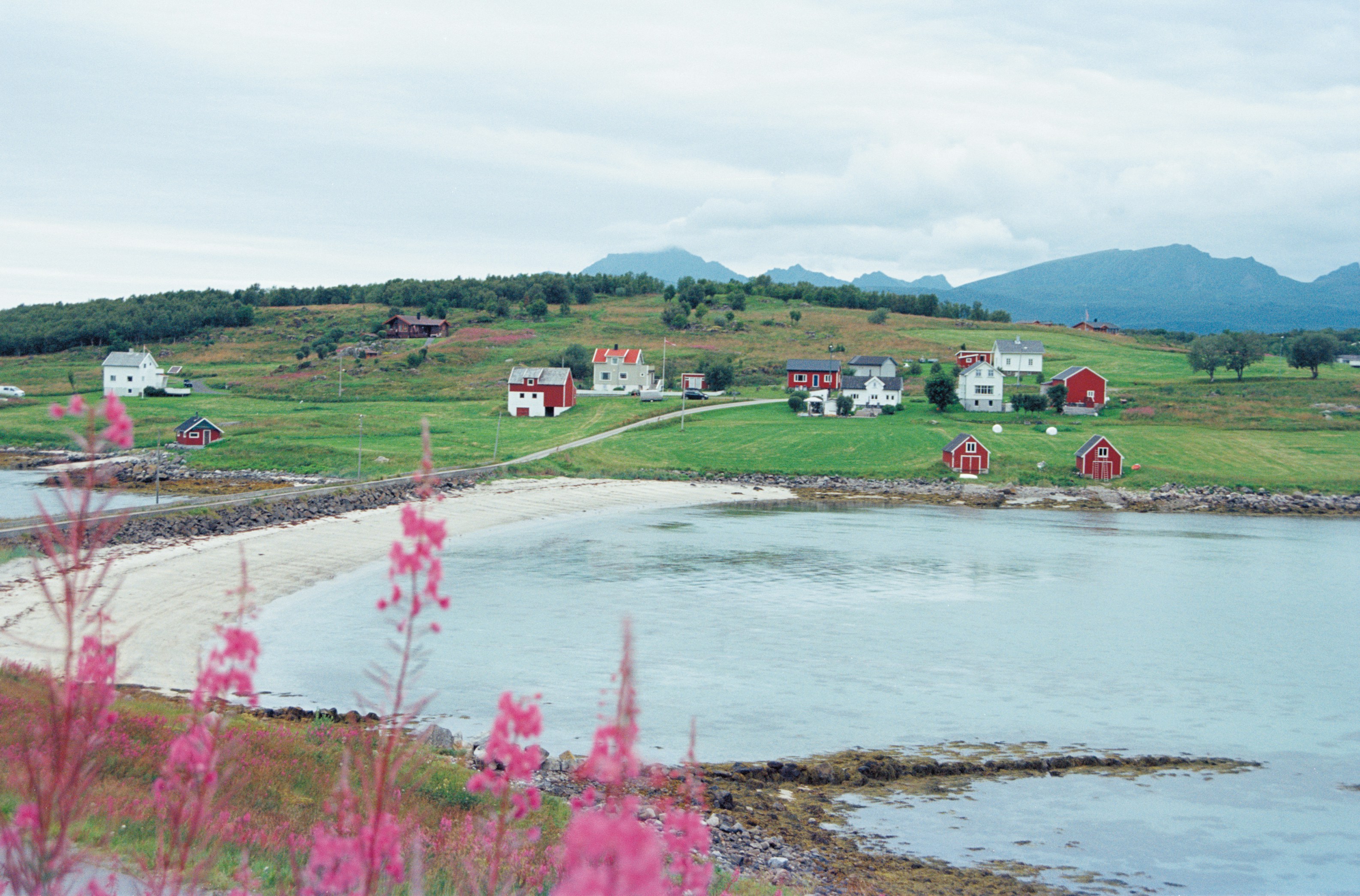 A coastal village is nestled amidst rolling hills.
