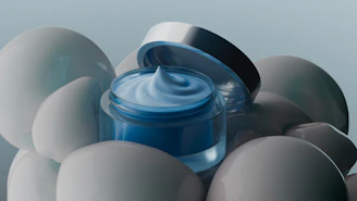 Cosmetic cream jar surrounded by spheres.