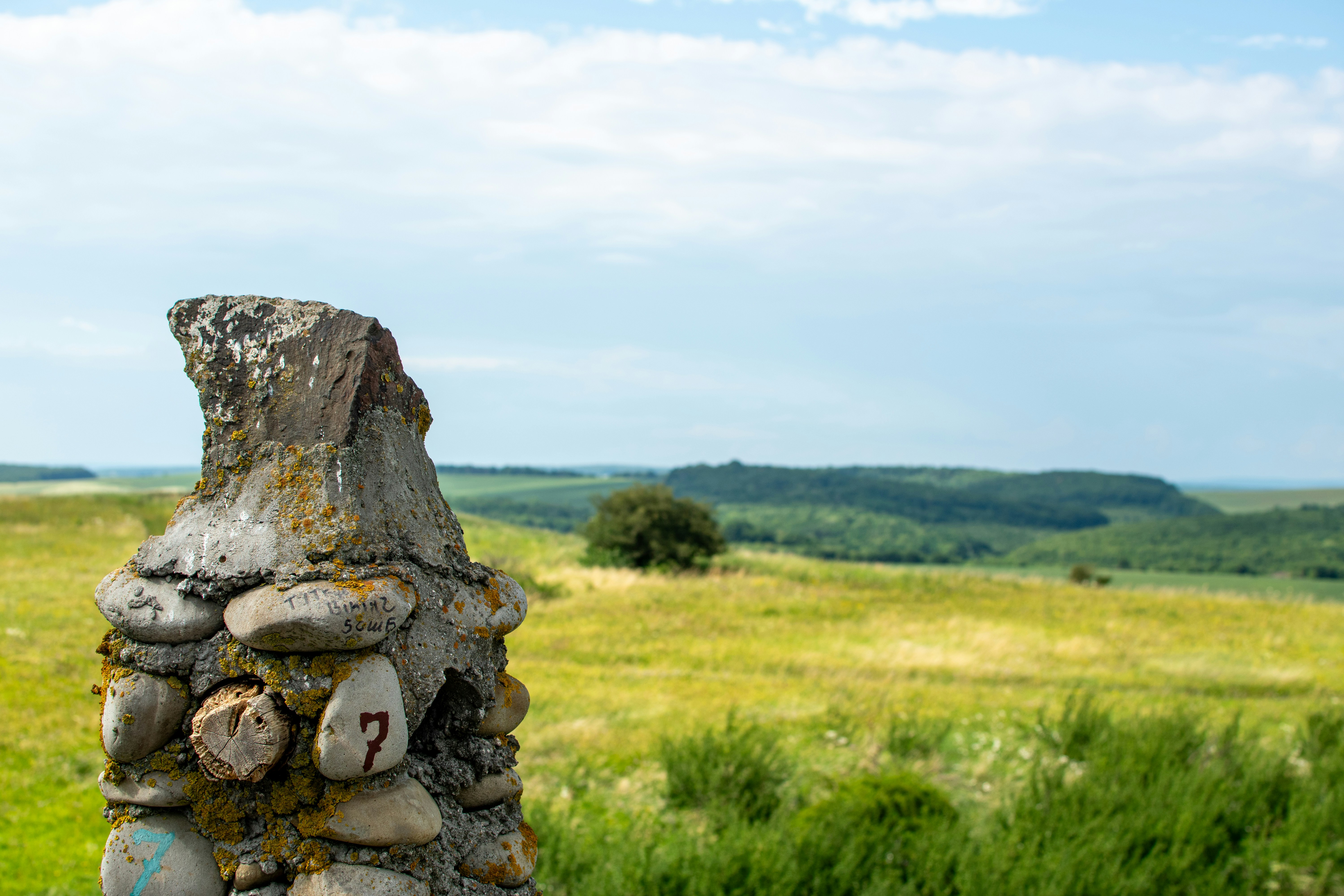 Old stone structure overlooks a grassy field.