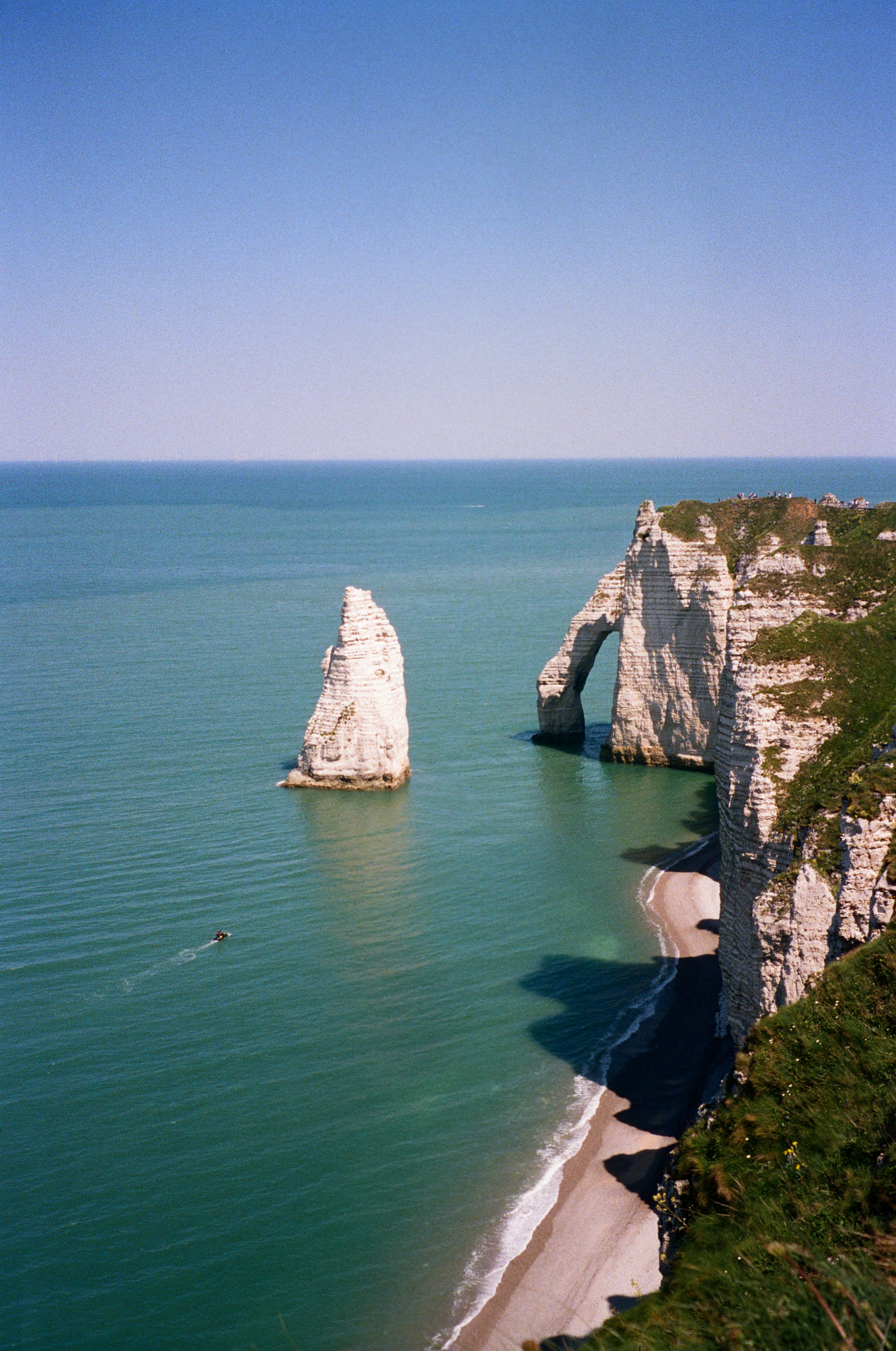 White cliffs stand tall over the tranquil ocean.