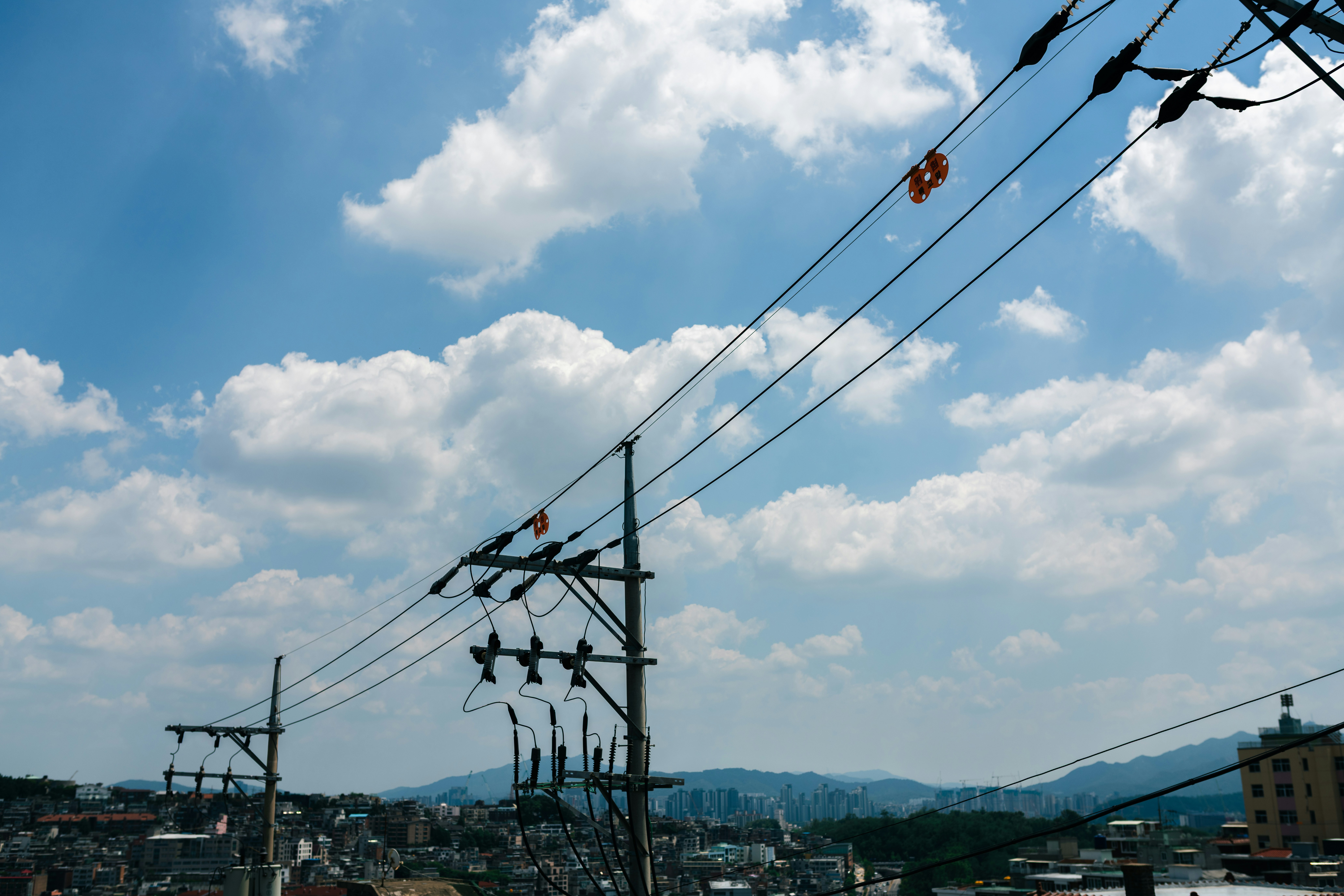 Power lines against a bright, cloudy sky - Free Photo on Unsplash