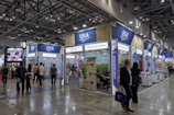 People are attending an exposition or trade show.