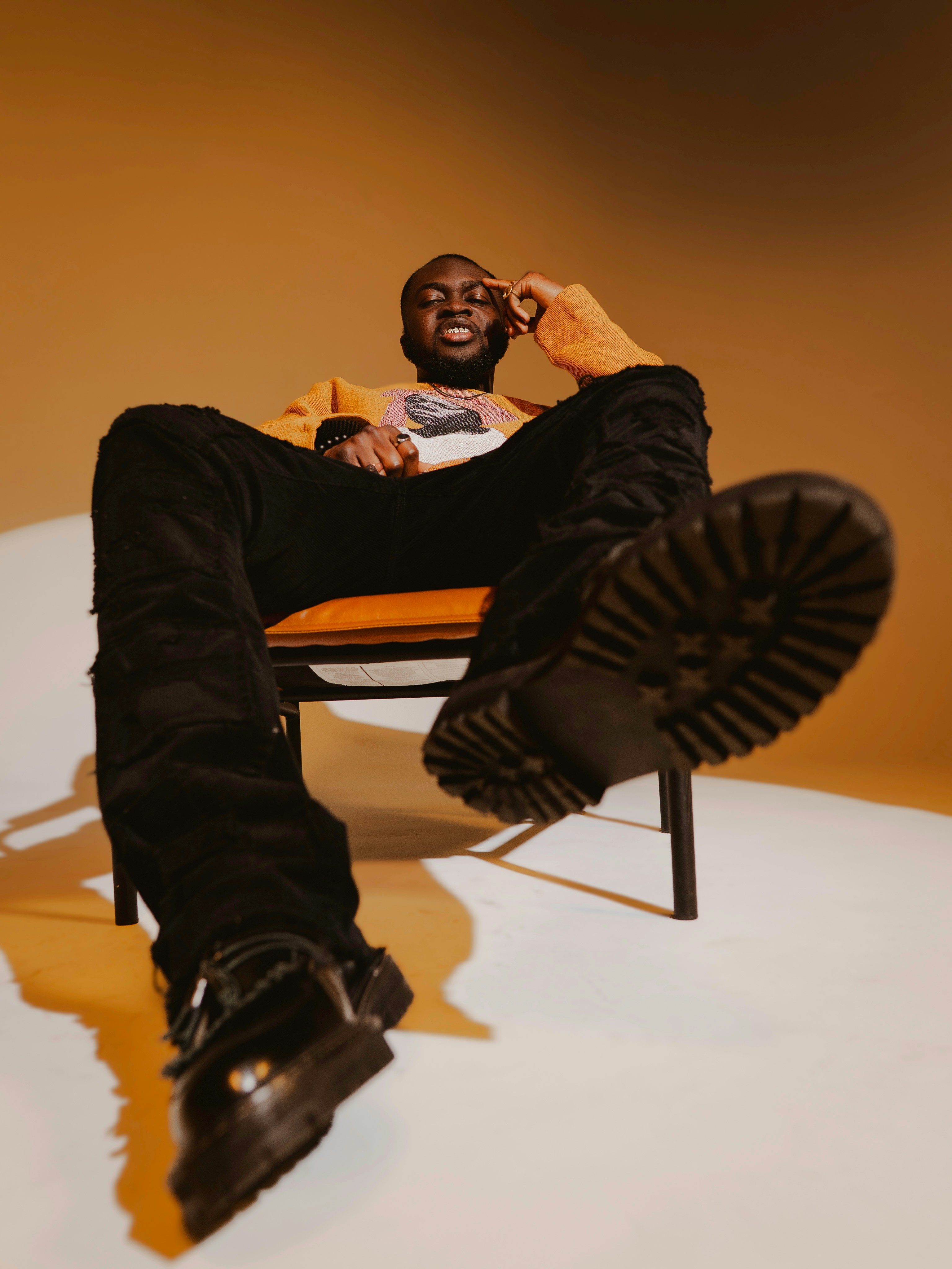 A man sits in a chair with his feet up.