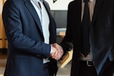 Two business partners shaking hands in agreement.