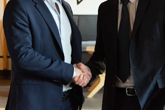 Two business partners shaking hands in agreement.
