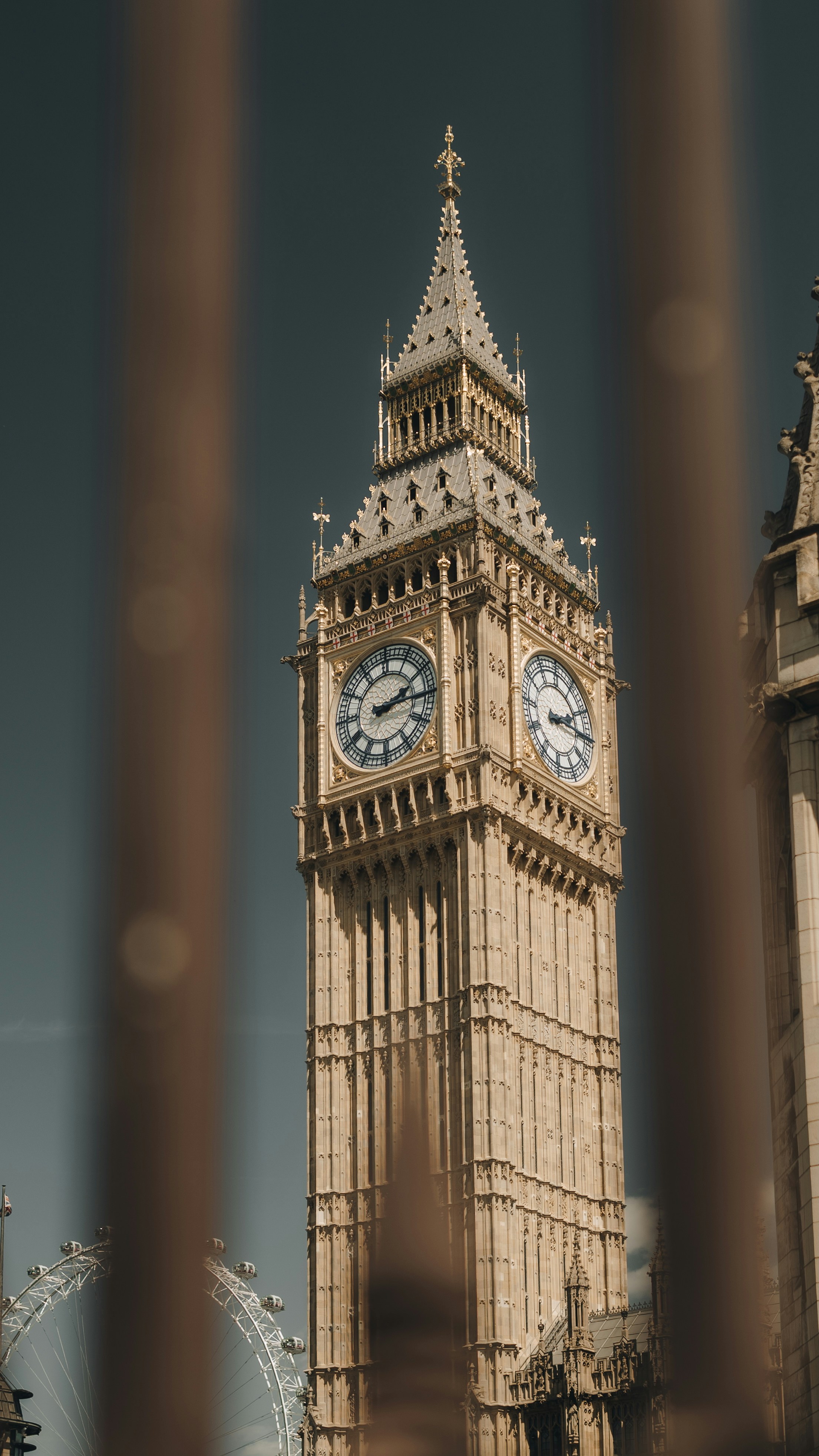 Big ben framed through some bars.