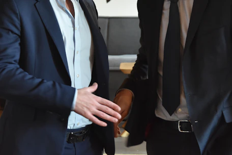Businessmen are shaking hands in a professional gesture.