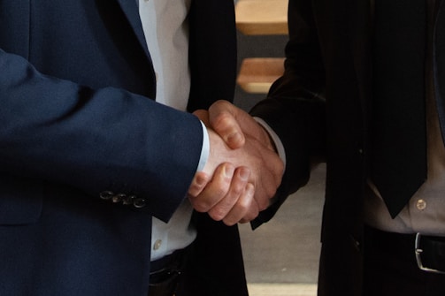 Business partners shake hands, making a deal.