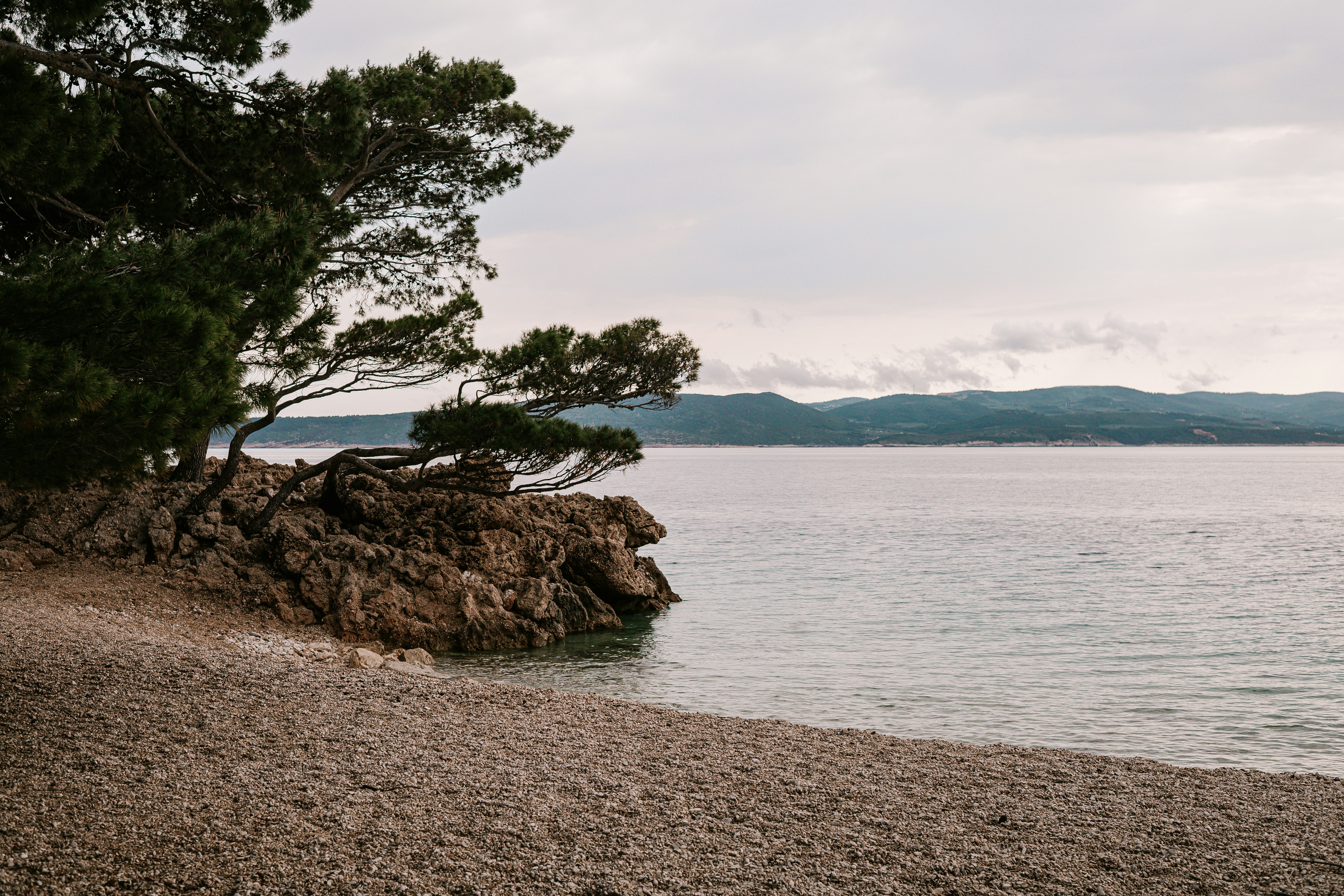 A rocky beach with a calm ocean view.