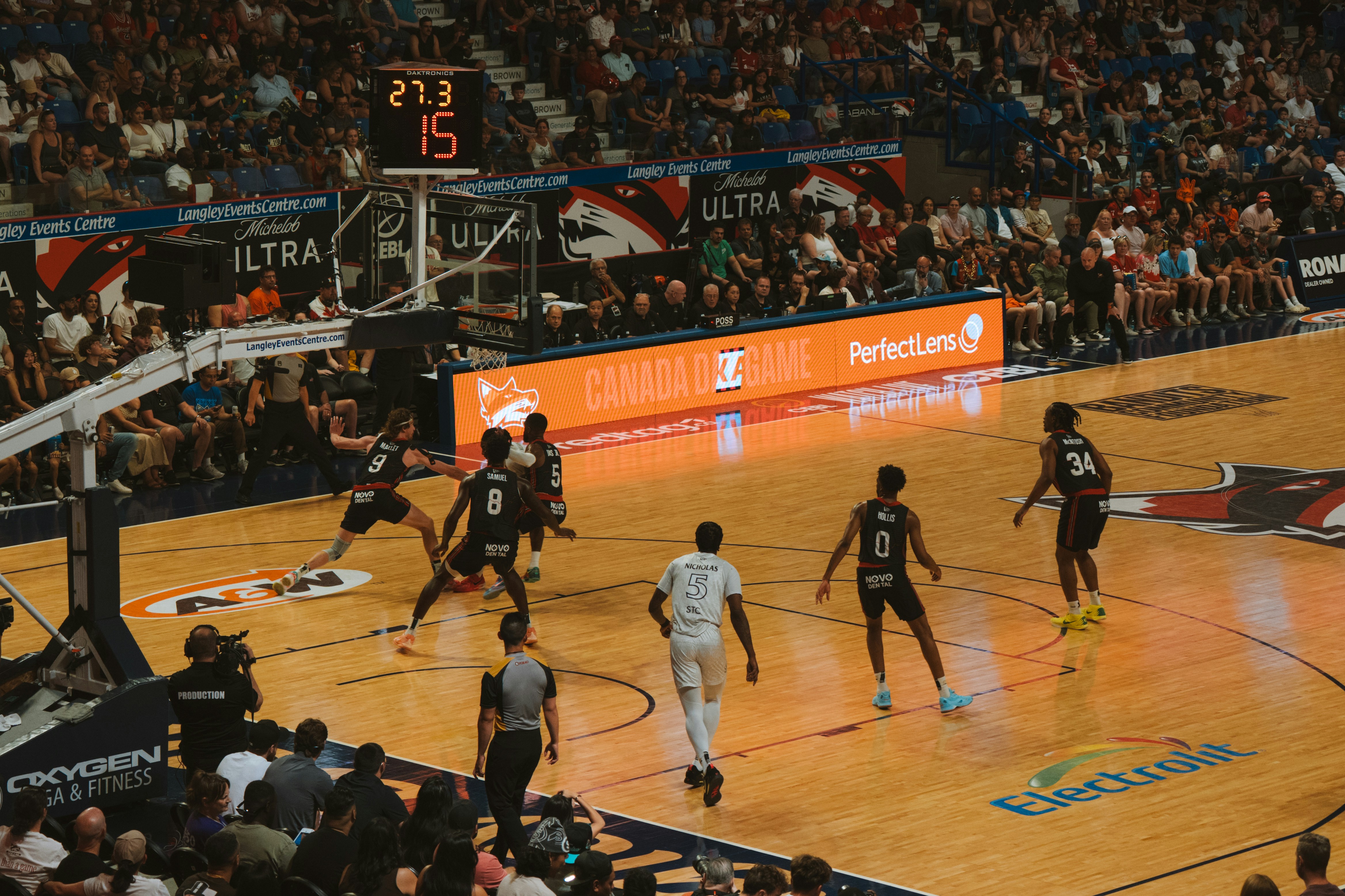 Basketball players compete on the court during a game.