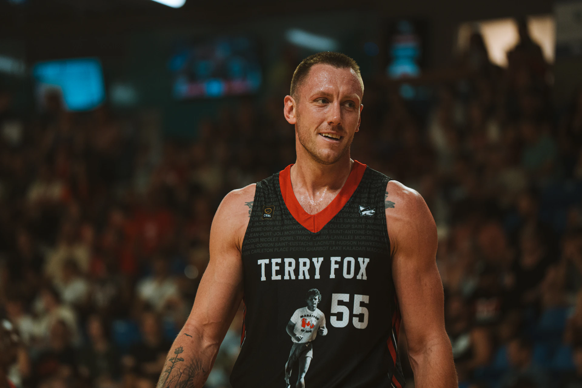 A basketball player is wearing a terry fox jersey.
