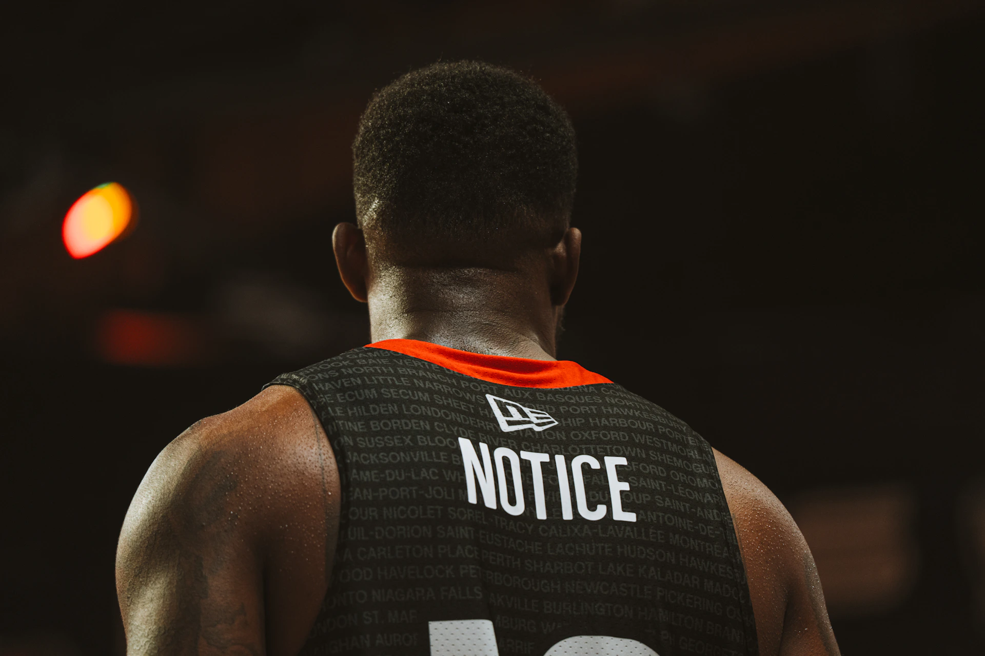 A basketball player's back view with 