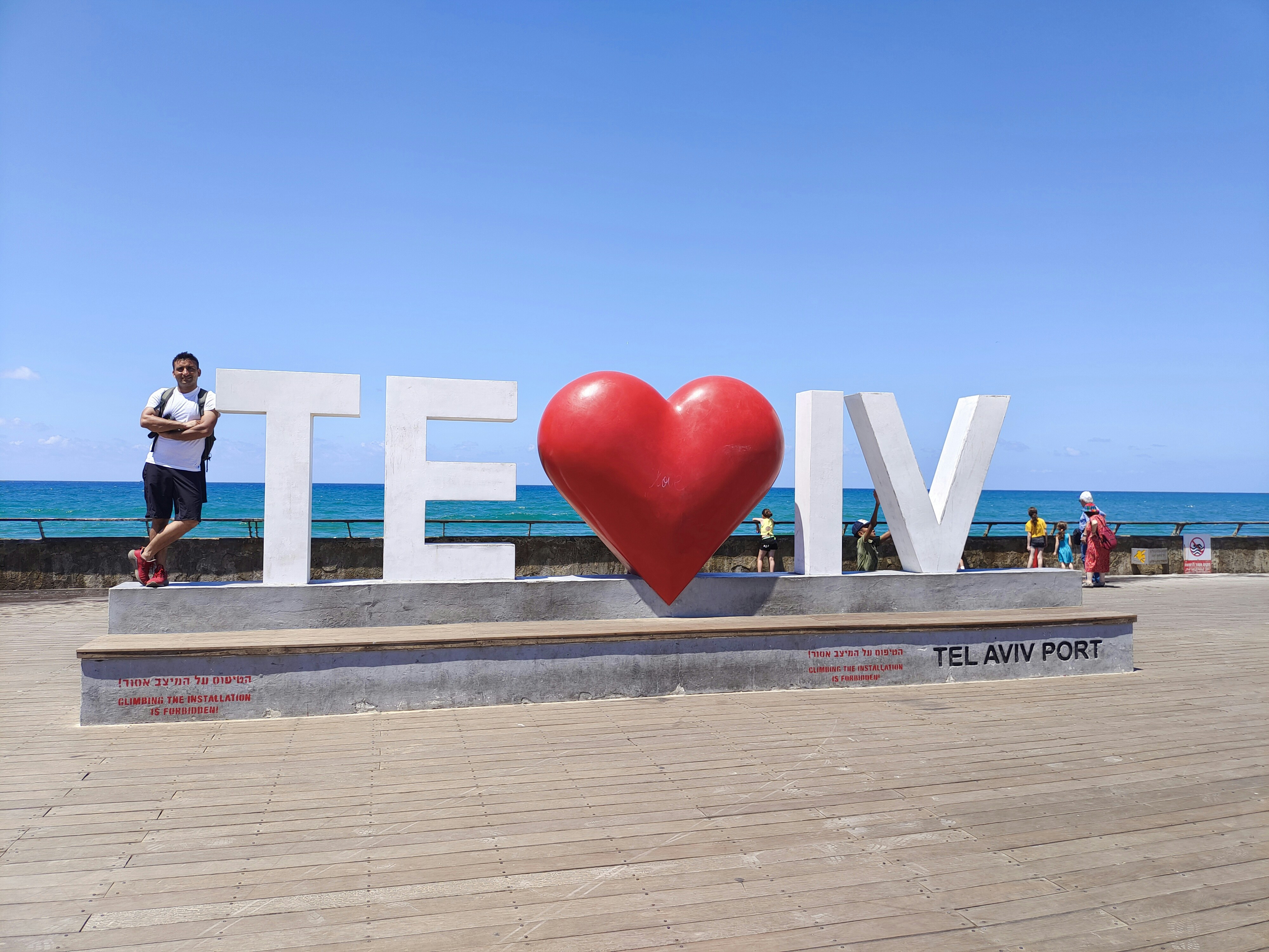 People pose with the tel aviv heart sign.