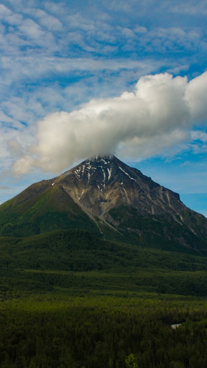 Mountain peak partially covered with clouds.
