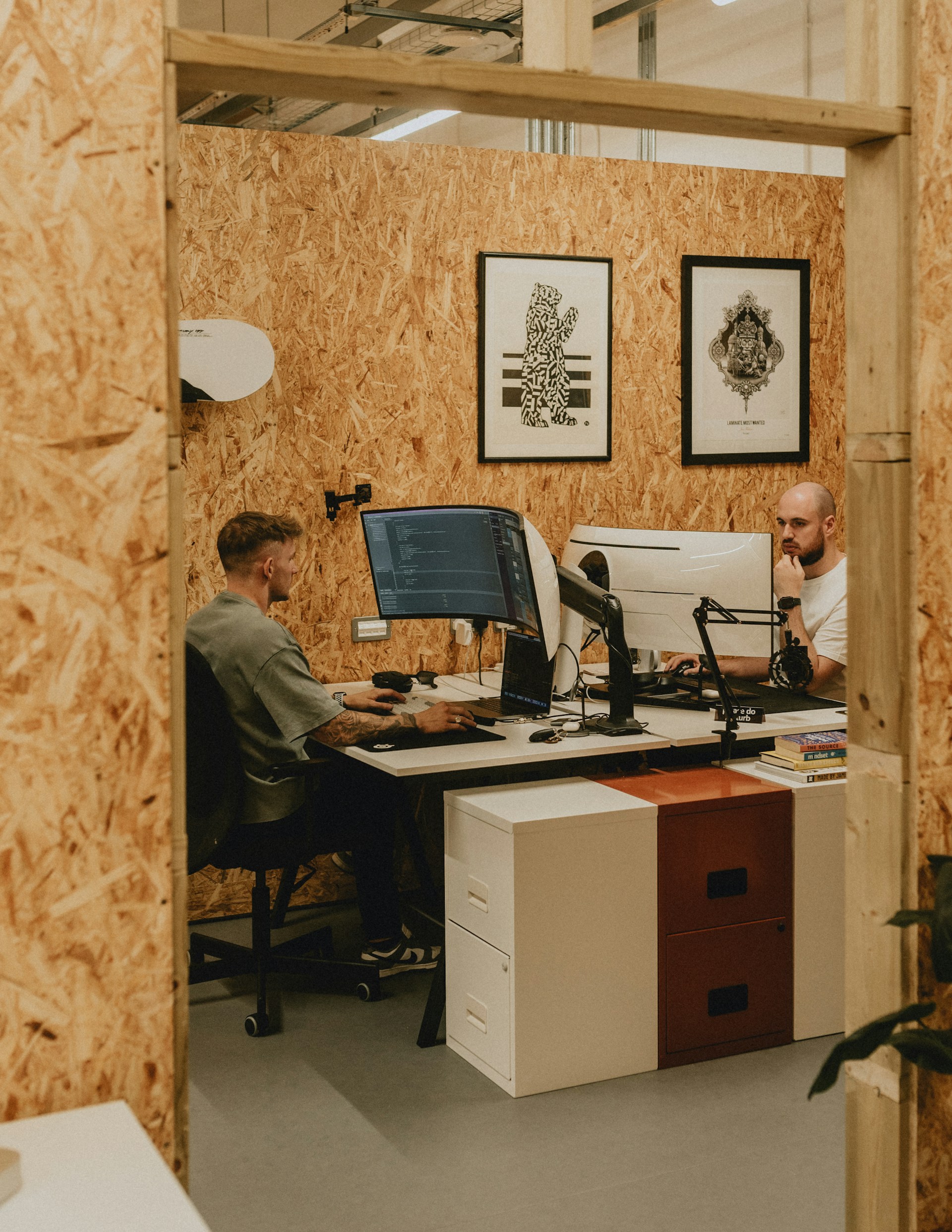 Two men working in a modern, shared office space.