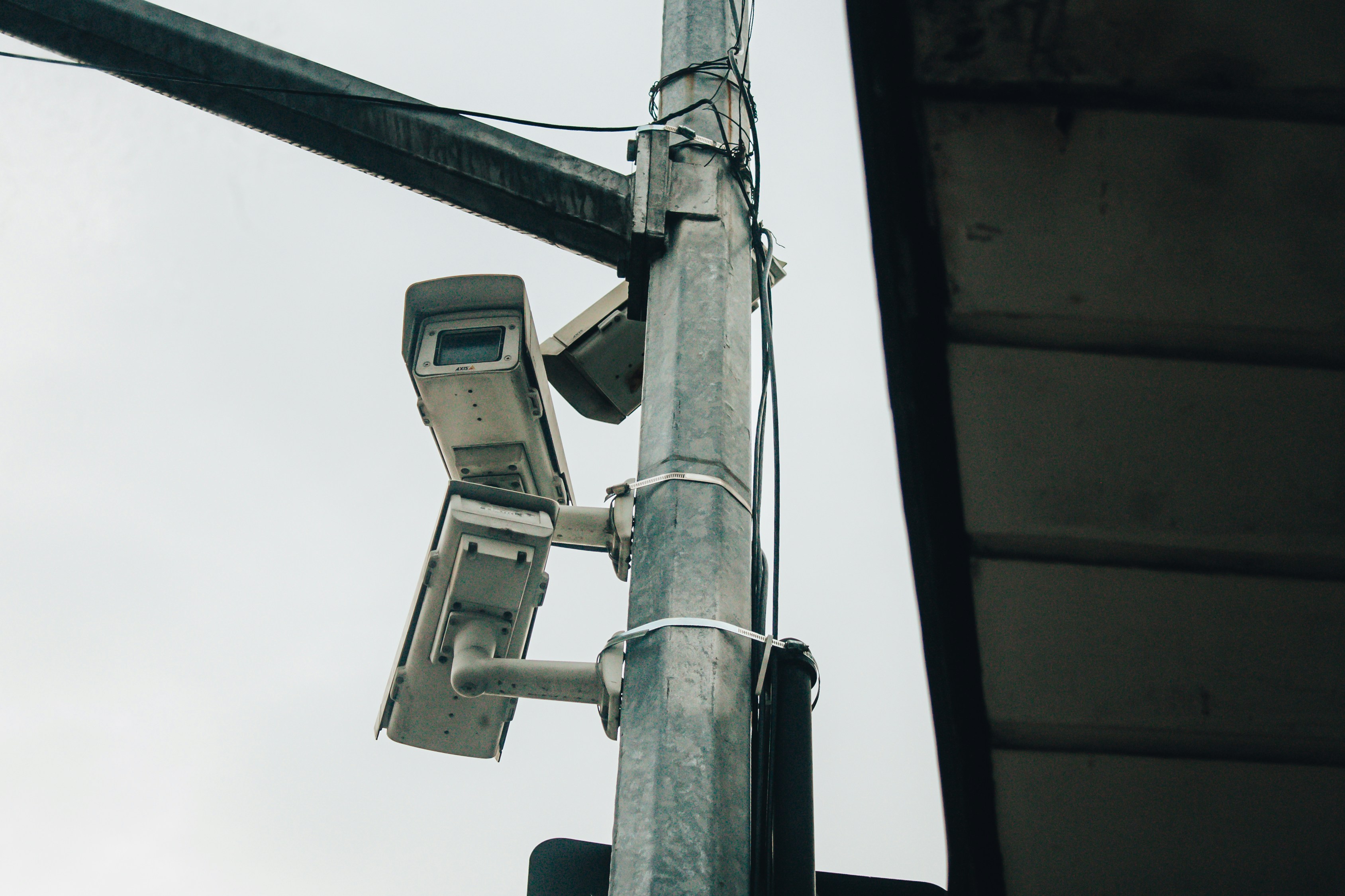 Surveillance cameras are mounted on a metal pole.