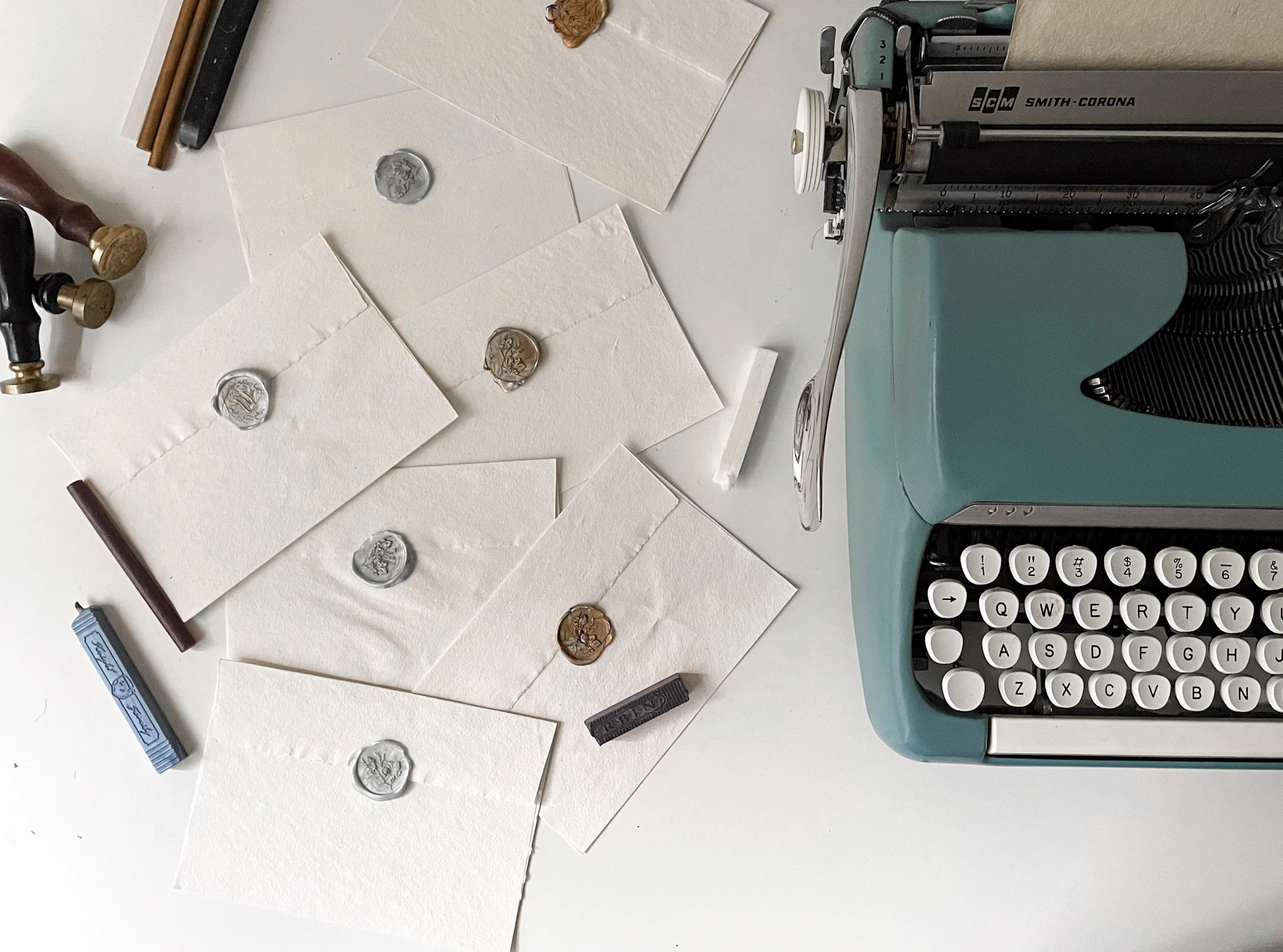 Envelopes, typewriter, and wax seals are arranged