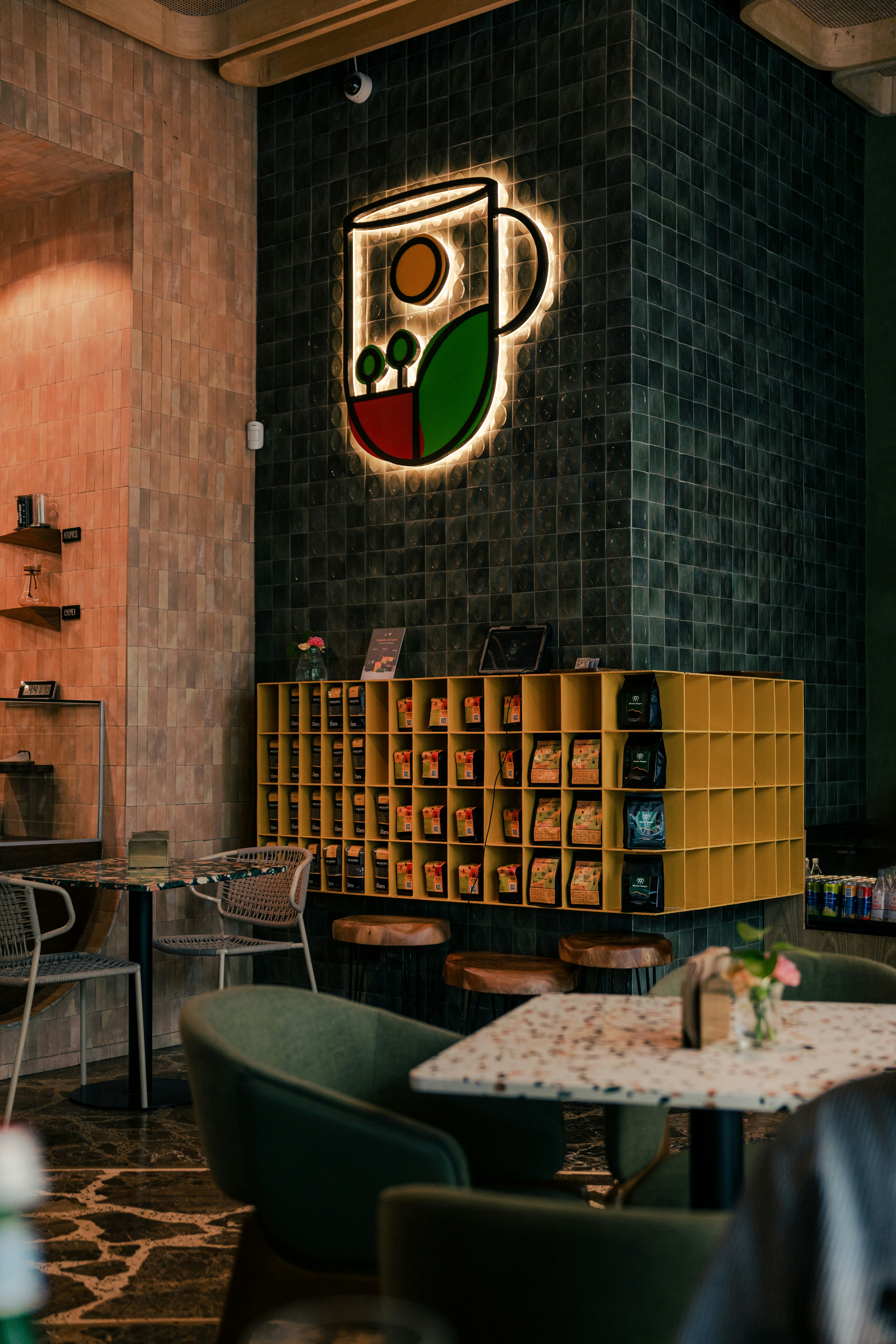 Coffee shop interior with a bright, lit logo.