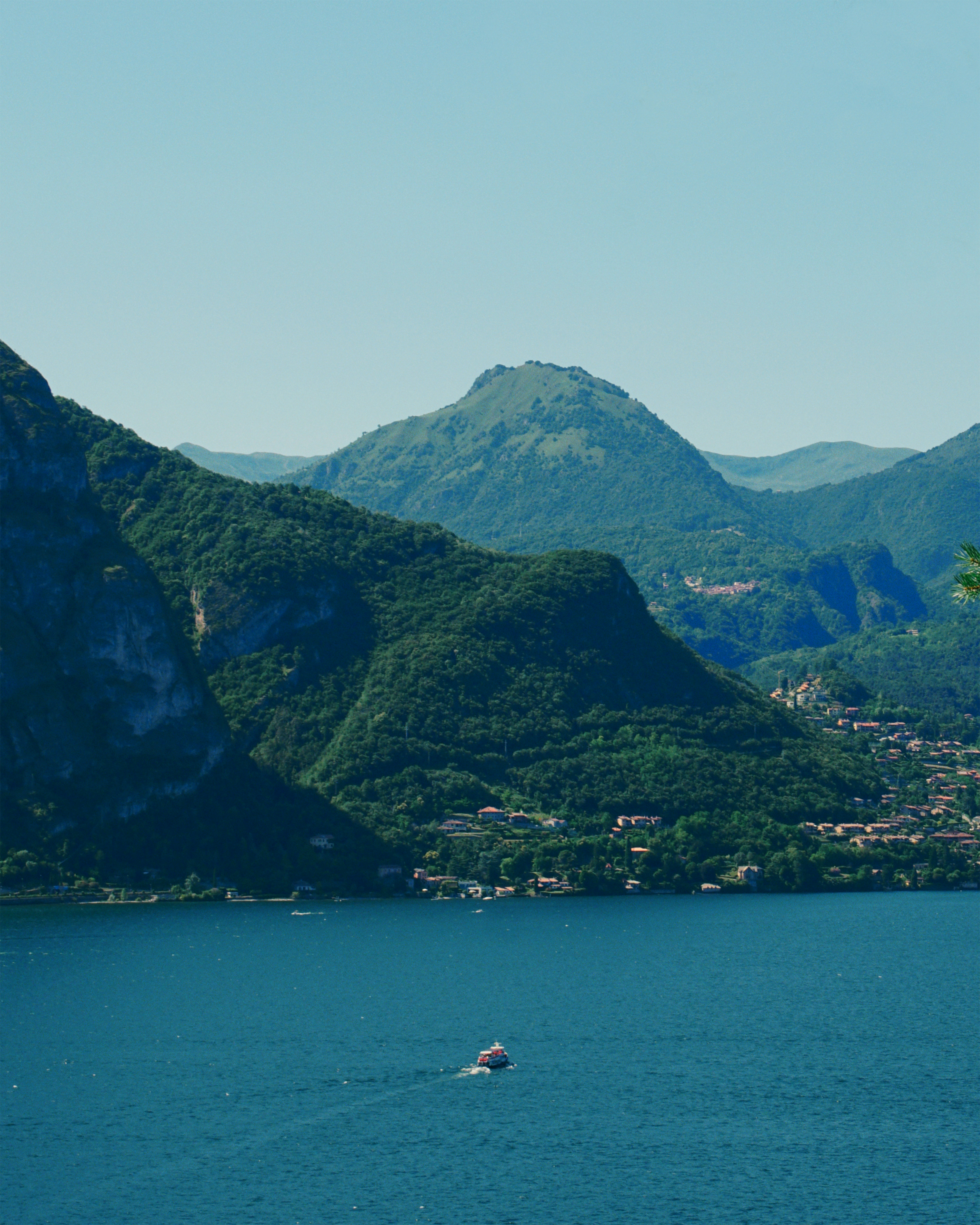 Mountains and lake under a clear, blue sky.