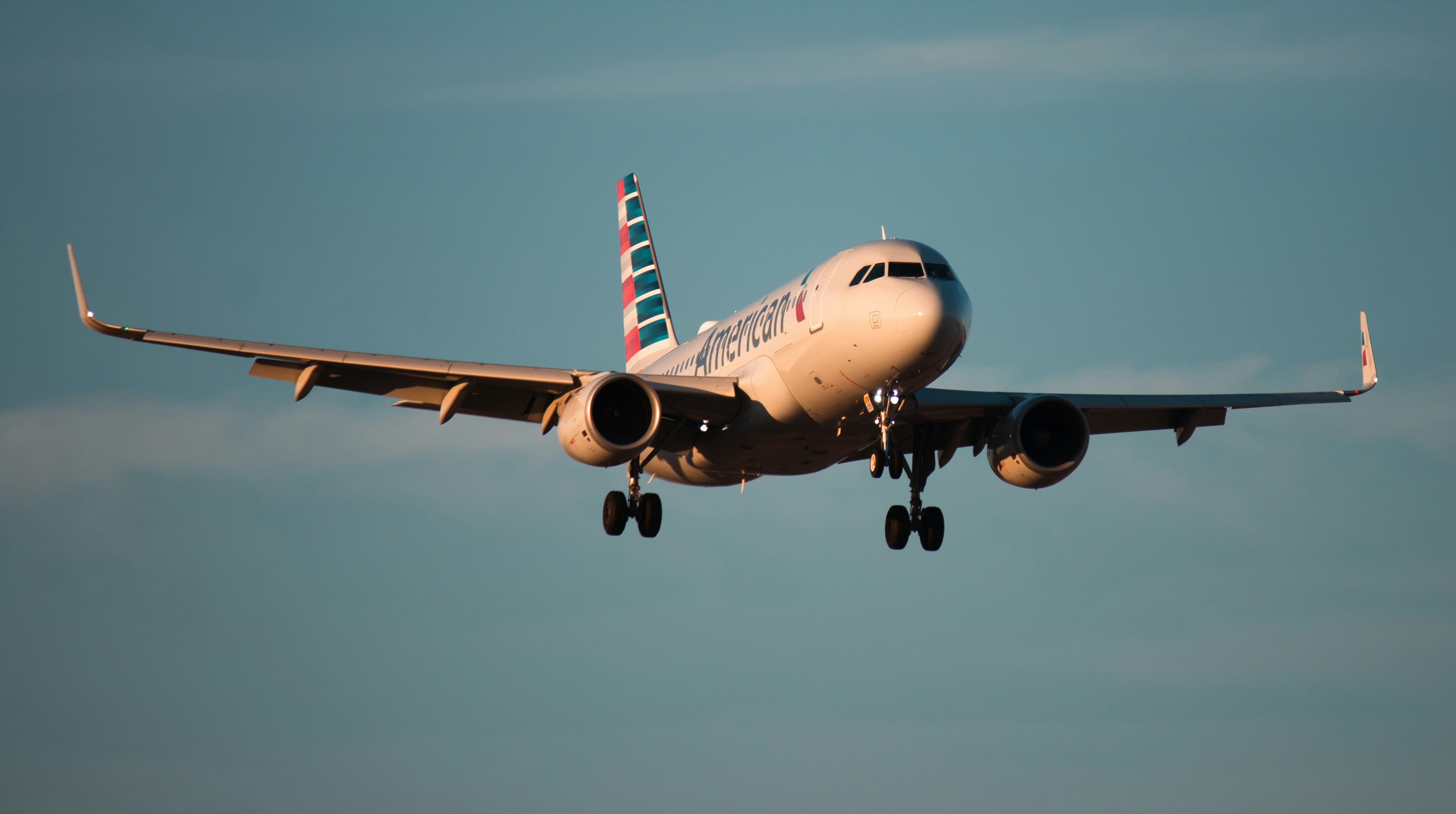 An american airlines plane is coming in for a landing.