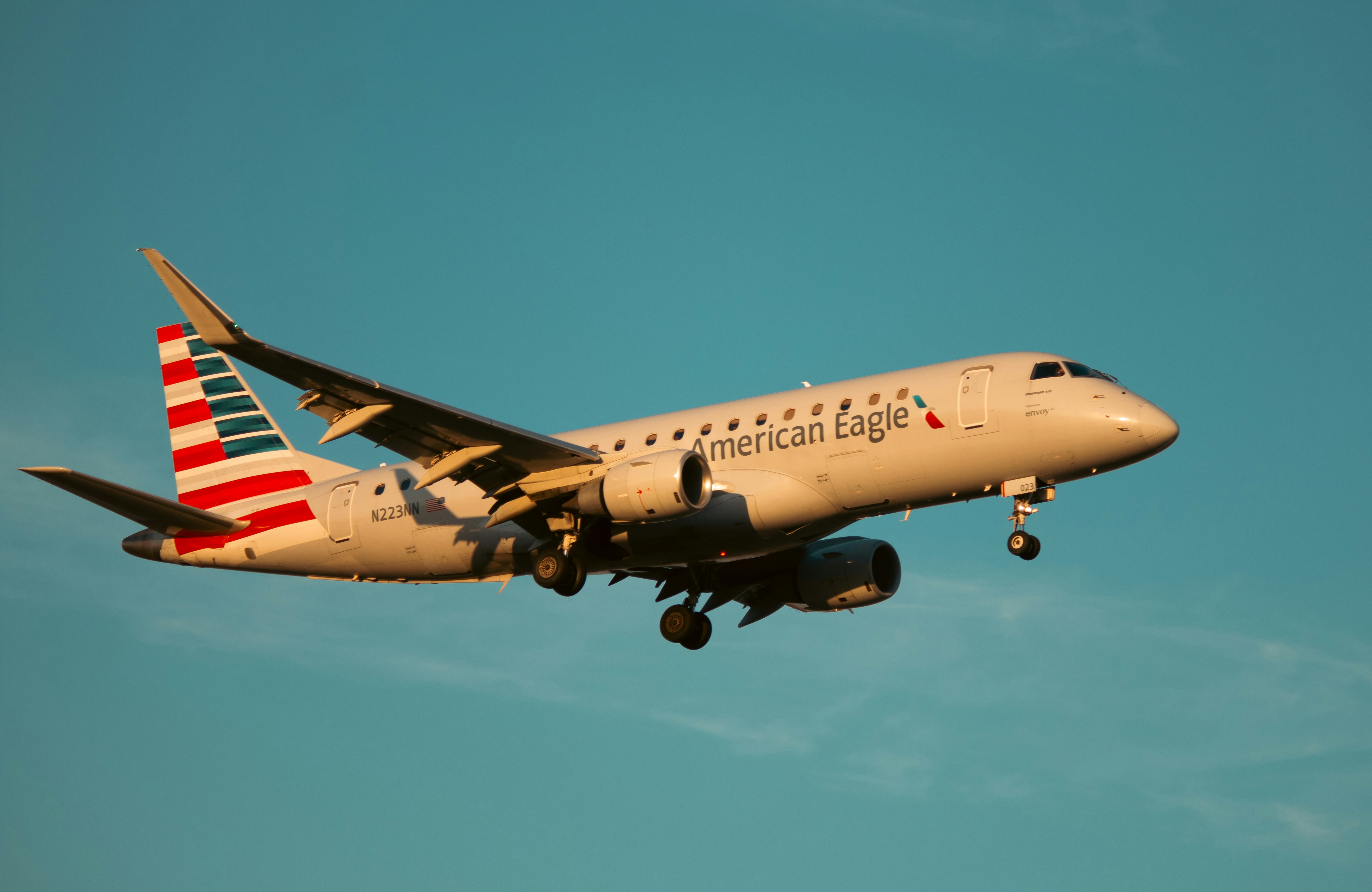 An american eagle plane flies in the sky.