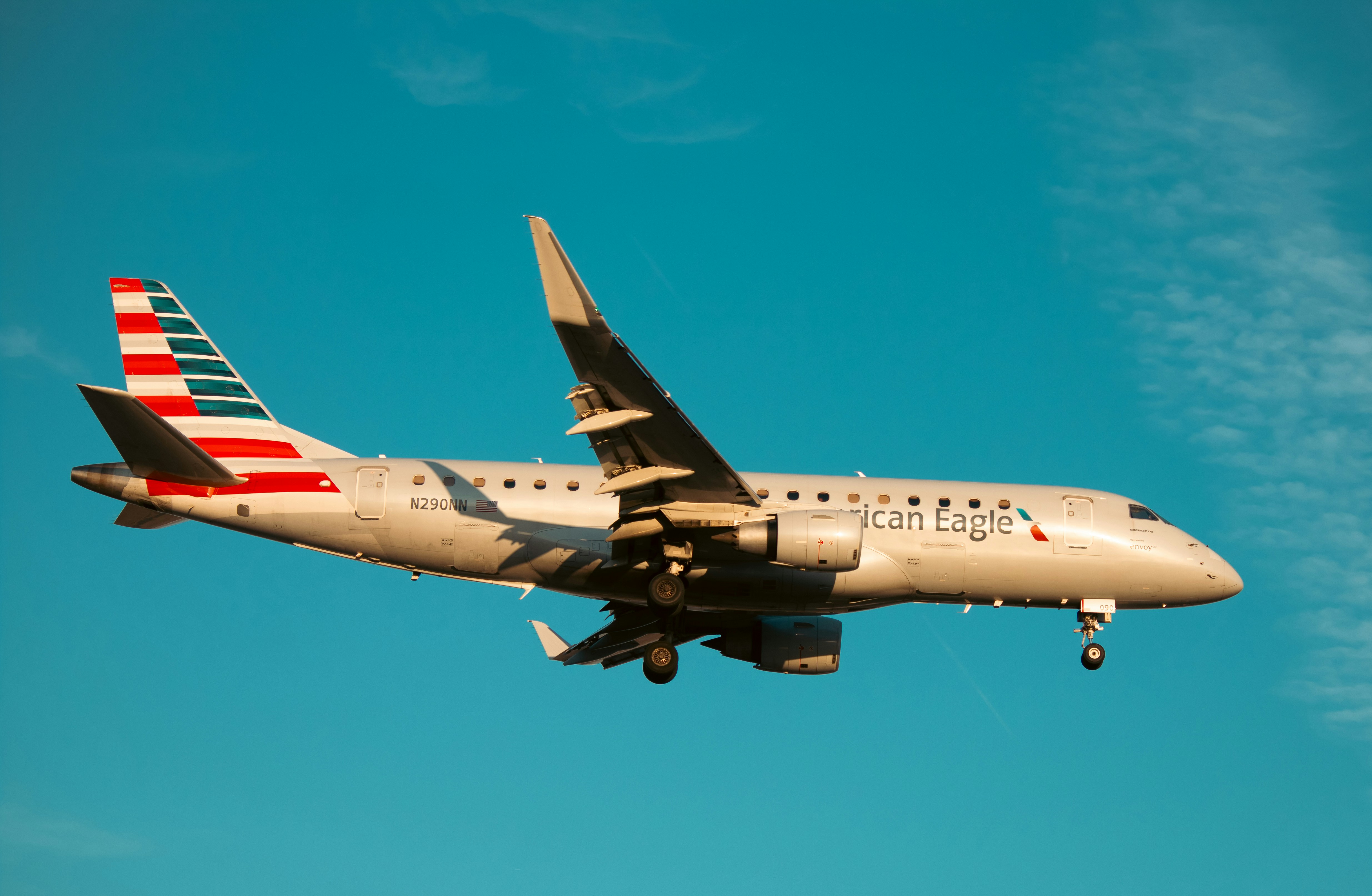 An american airlines plane is flying in the sky.