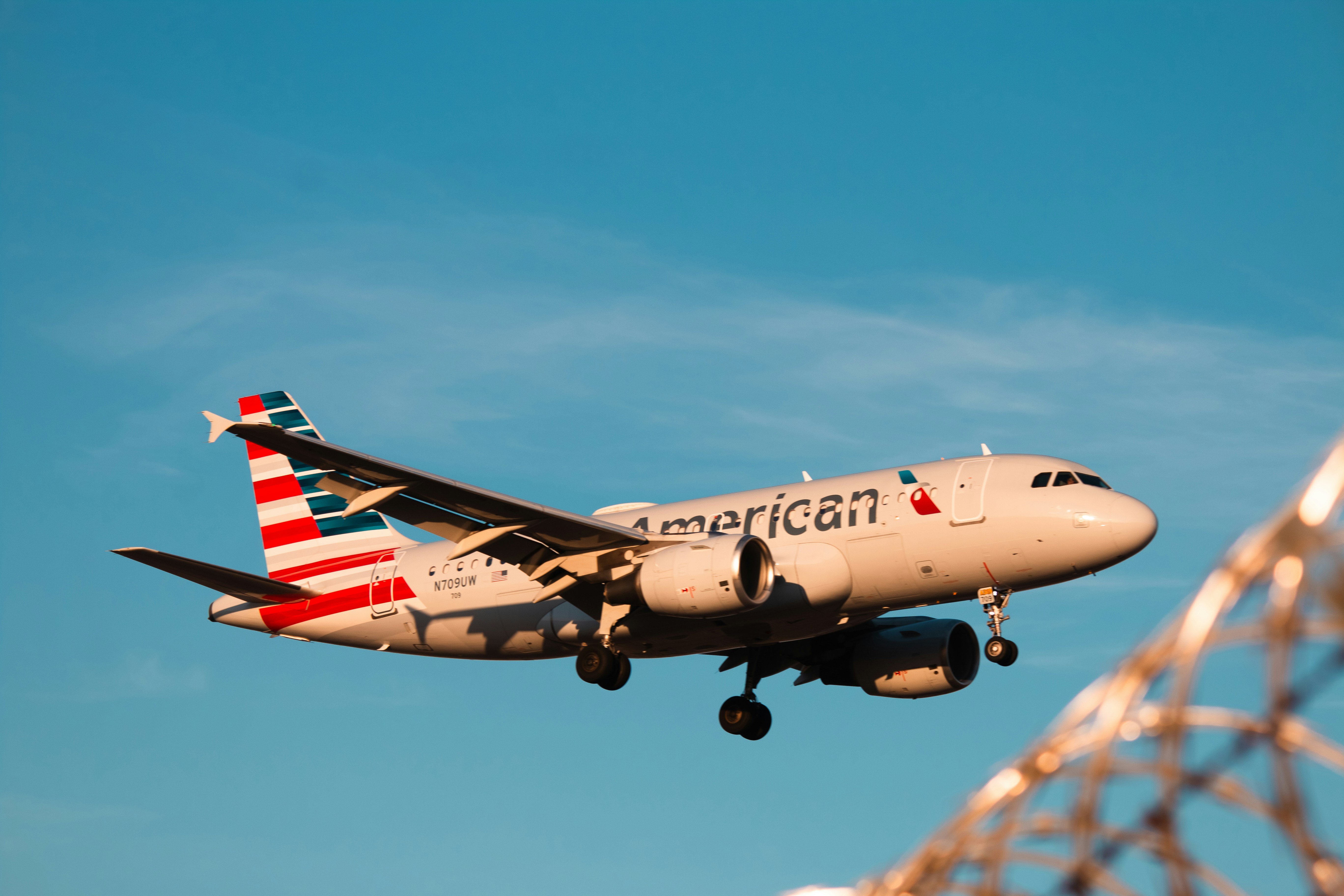 An american airlines plane is in the sky.