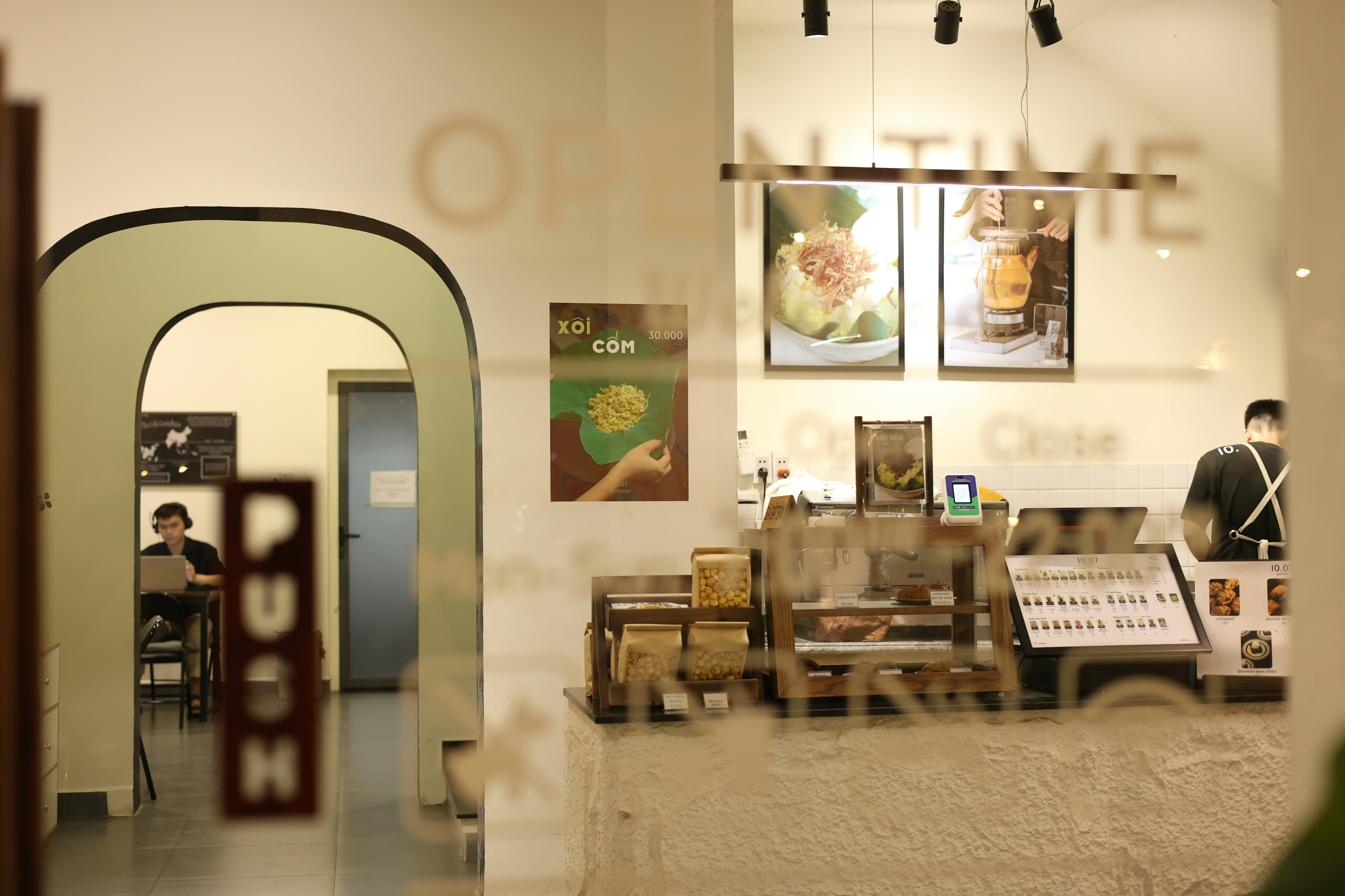 A restaurant interior is visible through the glass door.