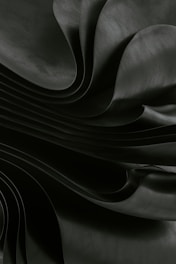 Dark, flowing fabric creates a dramatic, abstract effect.