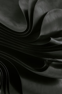 Dark, flowing fabric creates a dramatic, abstract effect.