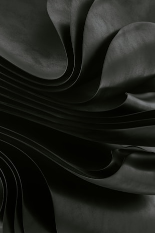 Dark, flowing fabric creates a dramatic, abstract effect.