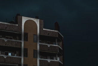 A building's corner under a dark blue sky.