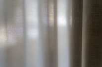 White curtains allow sunlight to gently filter through.