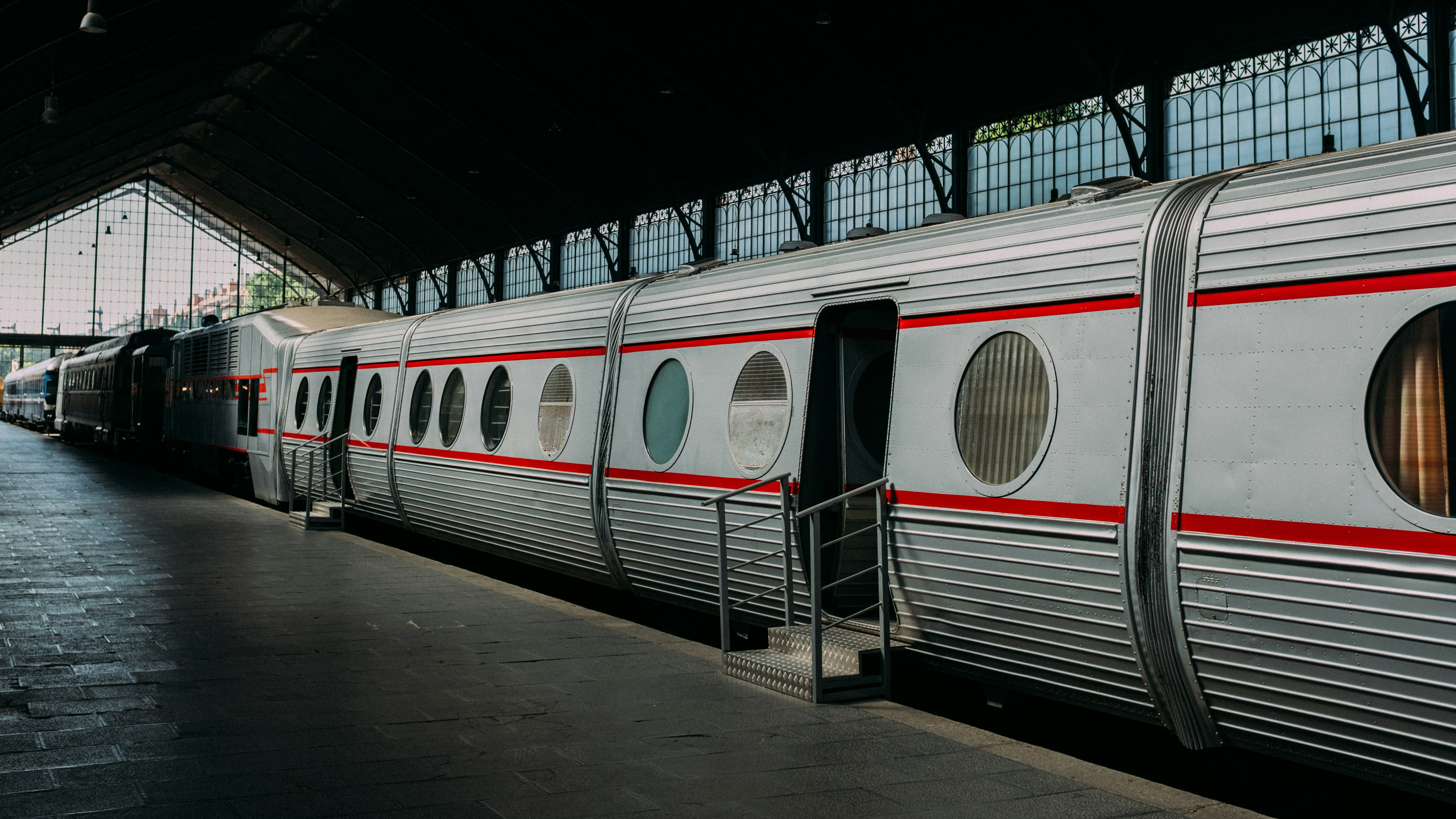 A shiny train is at a station.