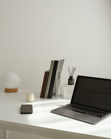 A minimal desk setup with a laptop and accessories.