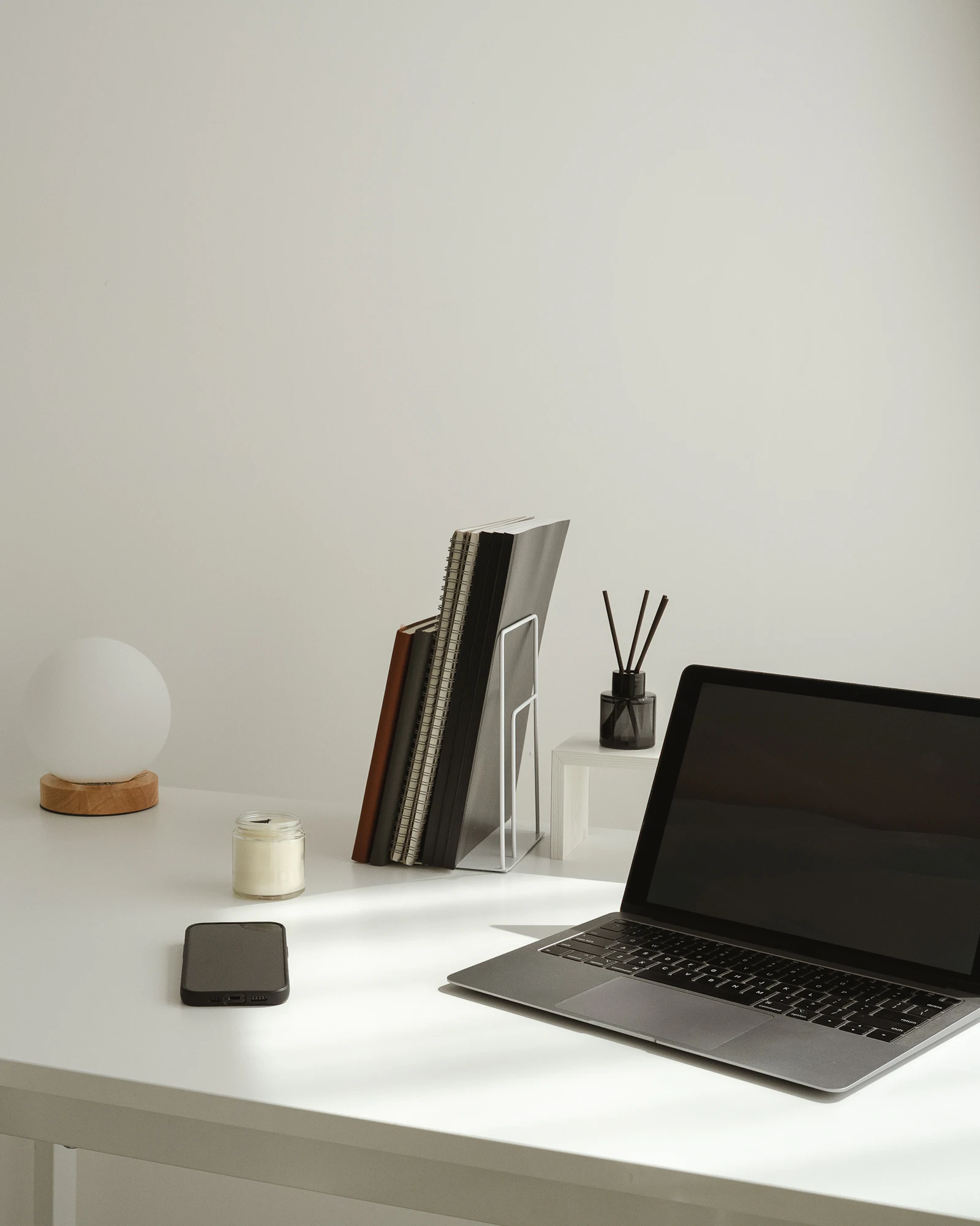 A calm, minimal desk setup with a laptop and a few tidy accessories