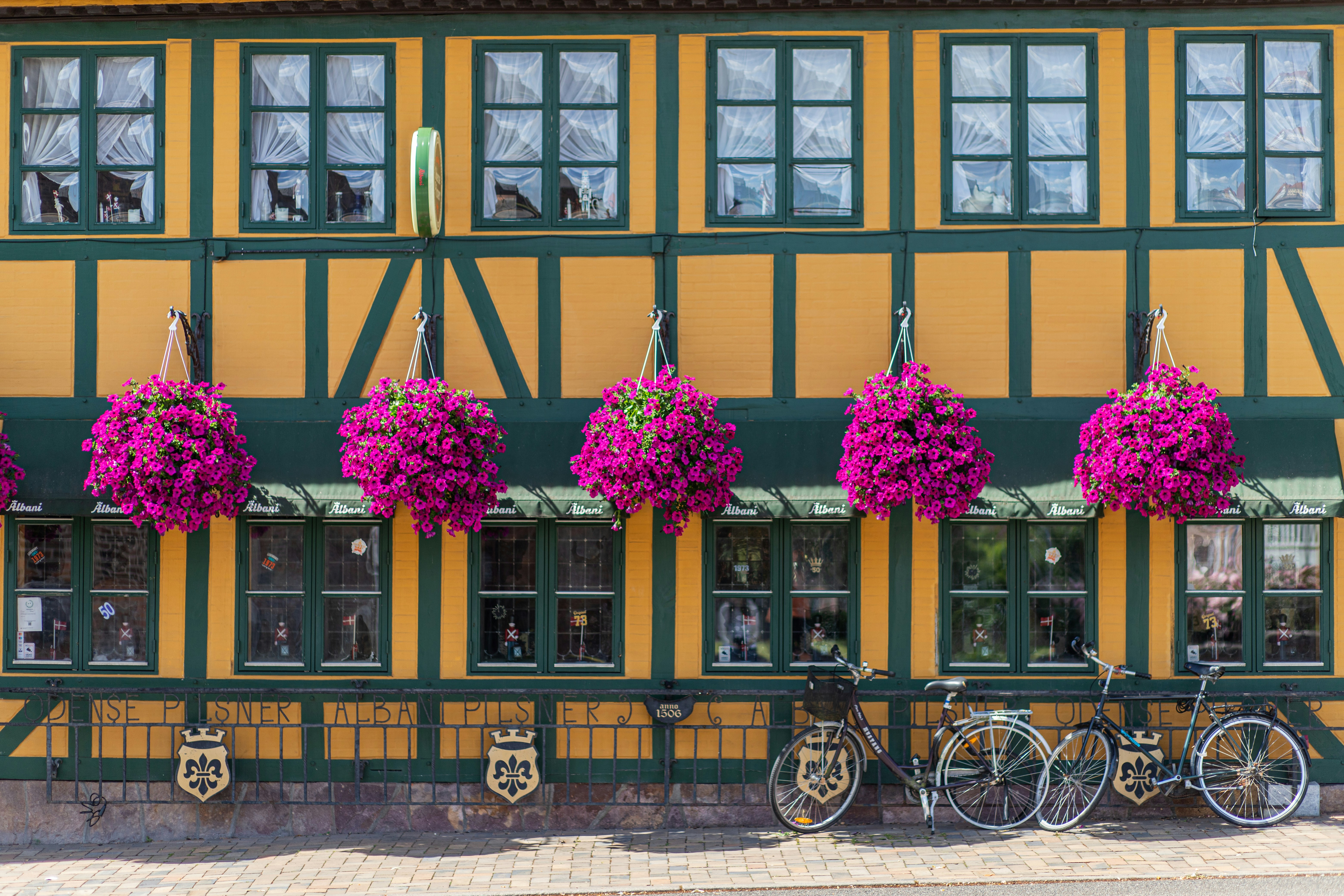 A charming, colorful building with hanging flower baskets.