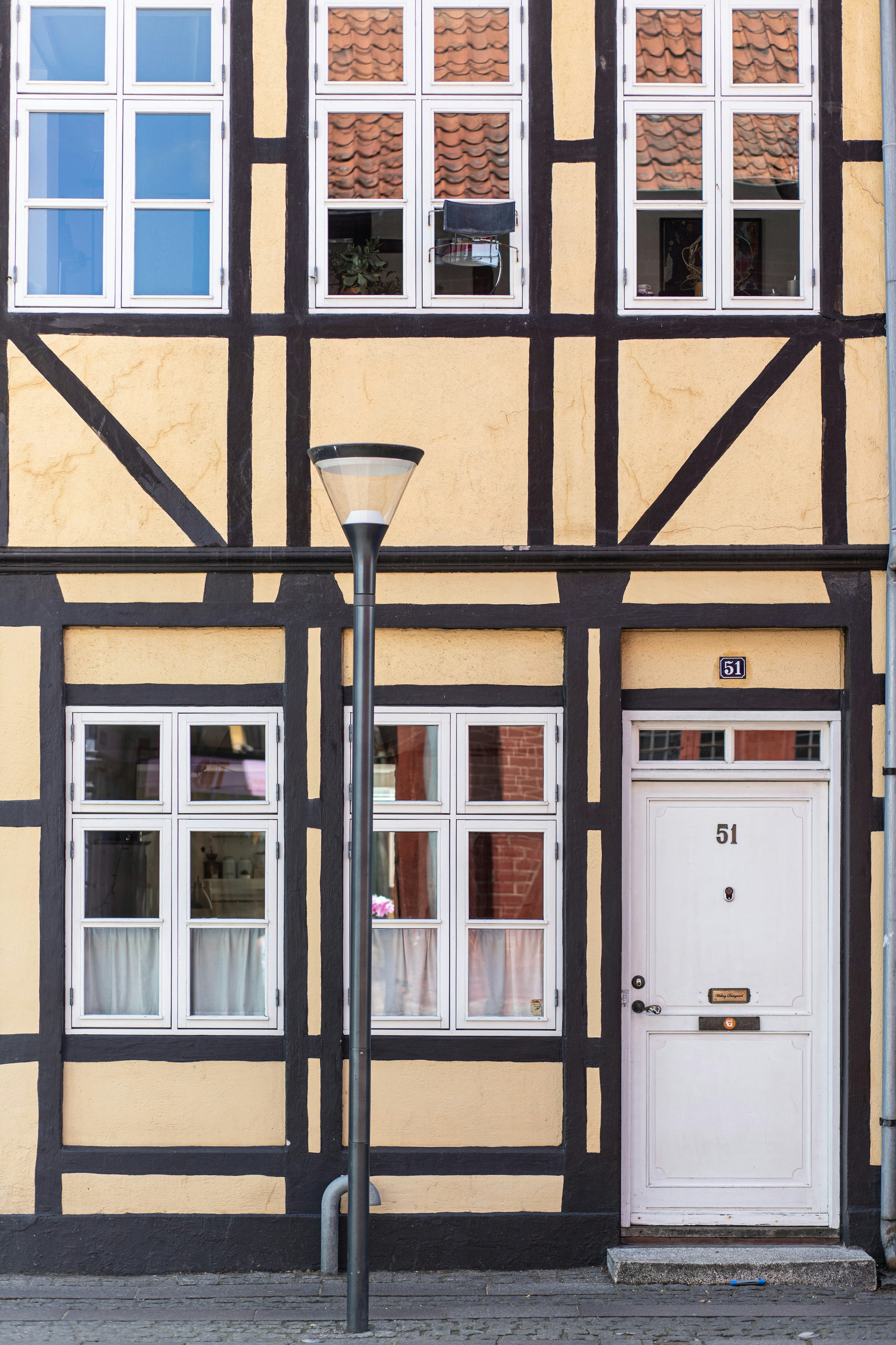 A yellow and black building with windows and a door.